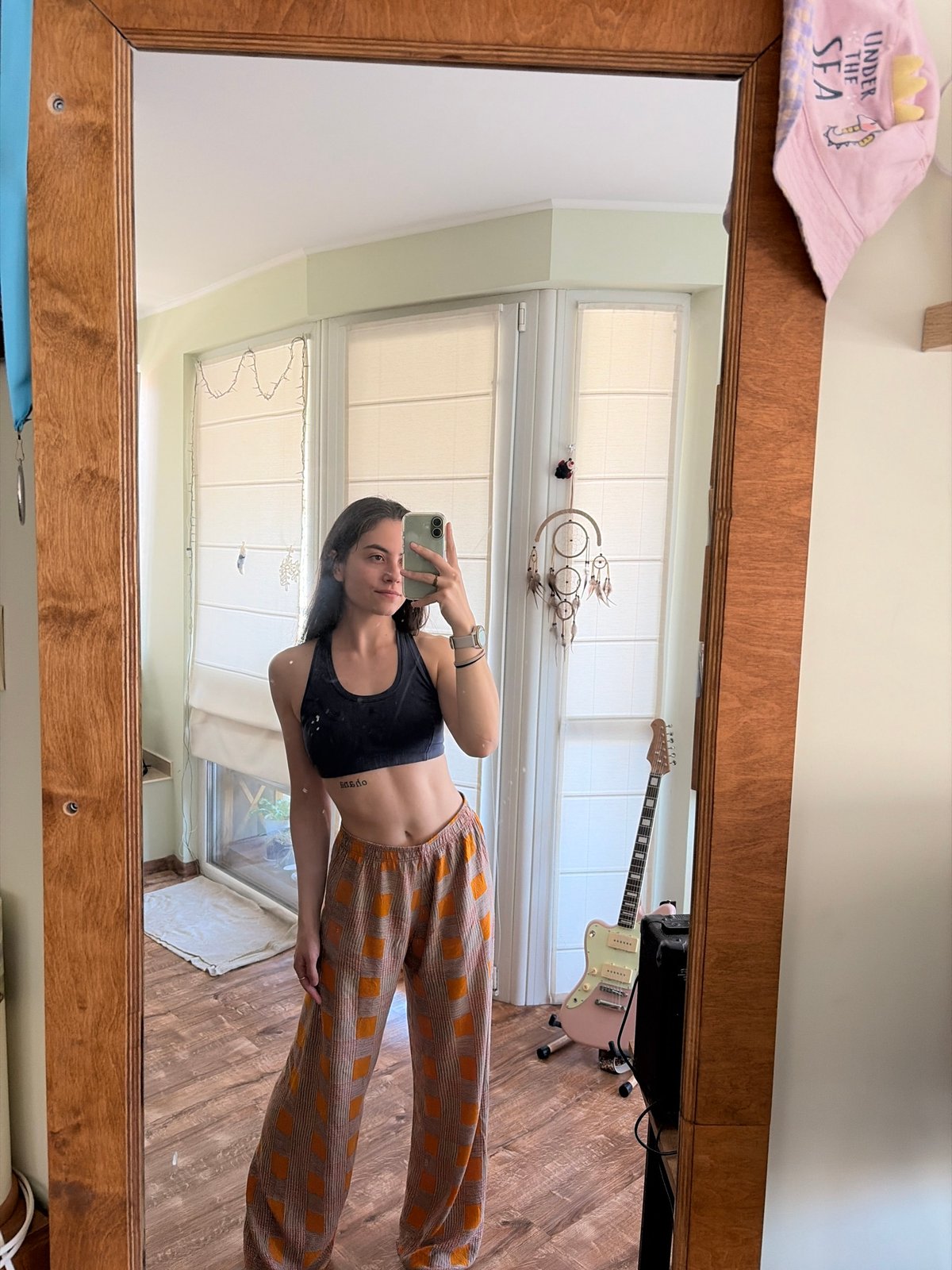 Back-to-back mirror selfies, same outfit, same space