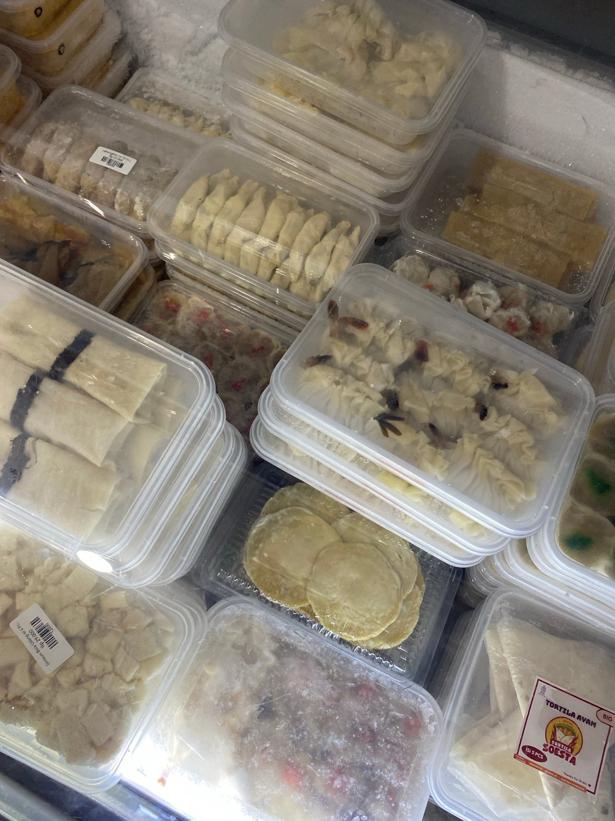 Freezer stocked with assorted packaged frozen baked goods