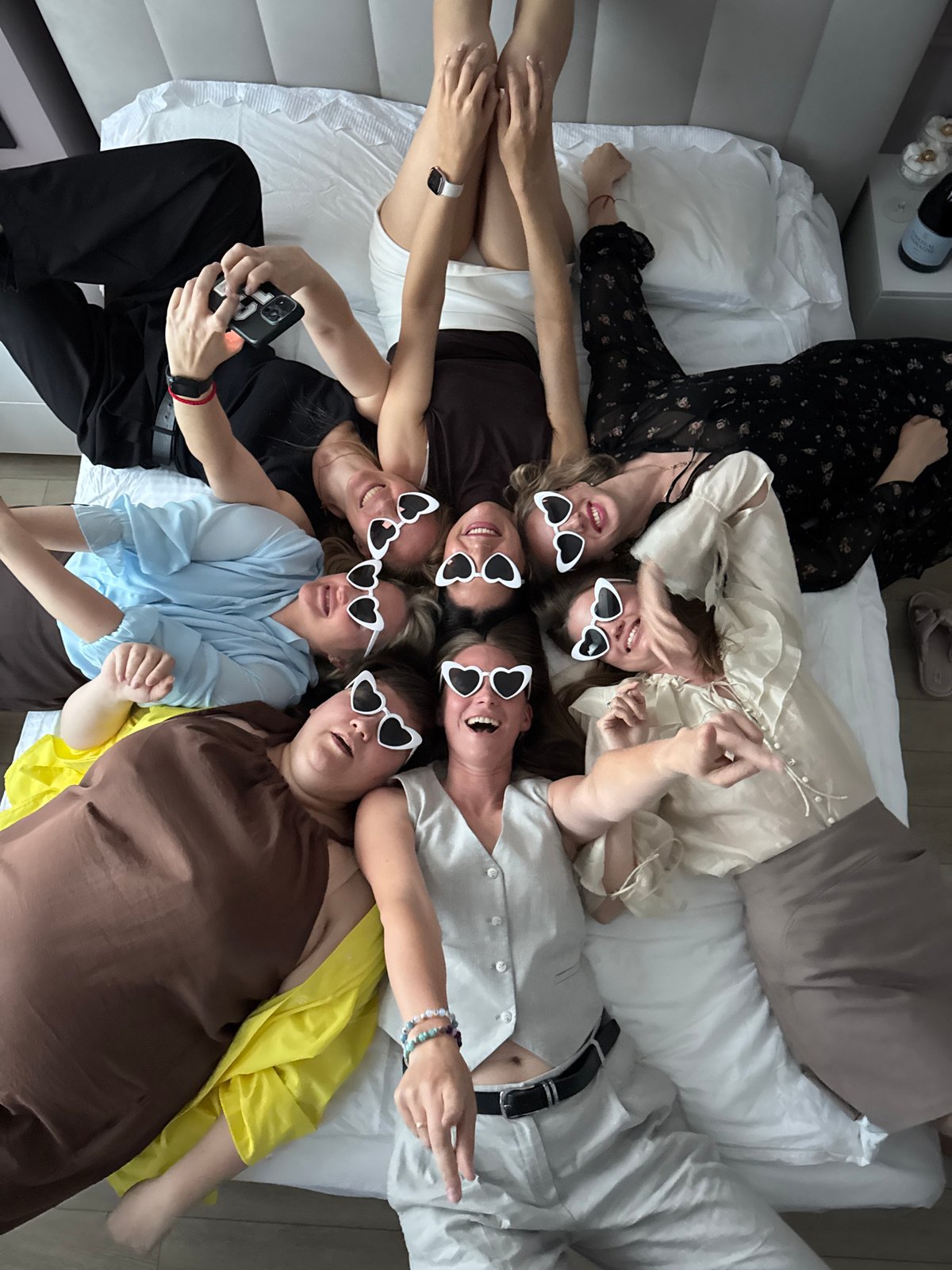 Seven women take group photo wearing heart sunglasses in Dzerzhinsk
