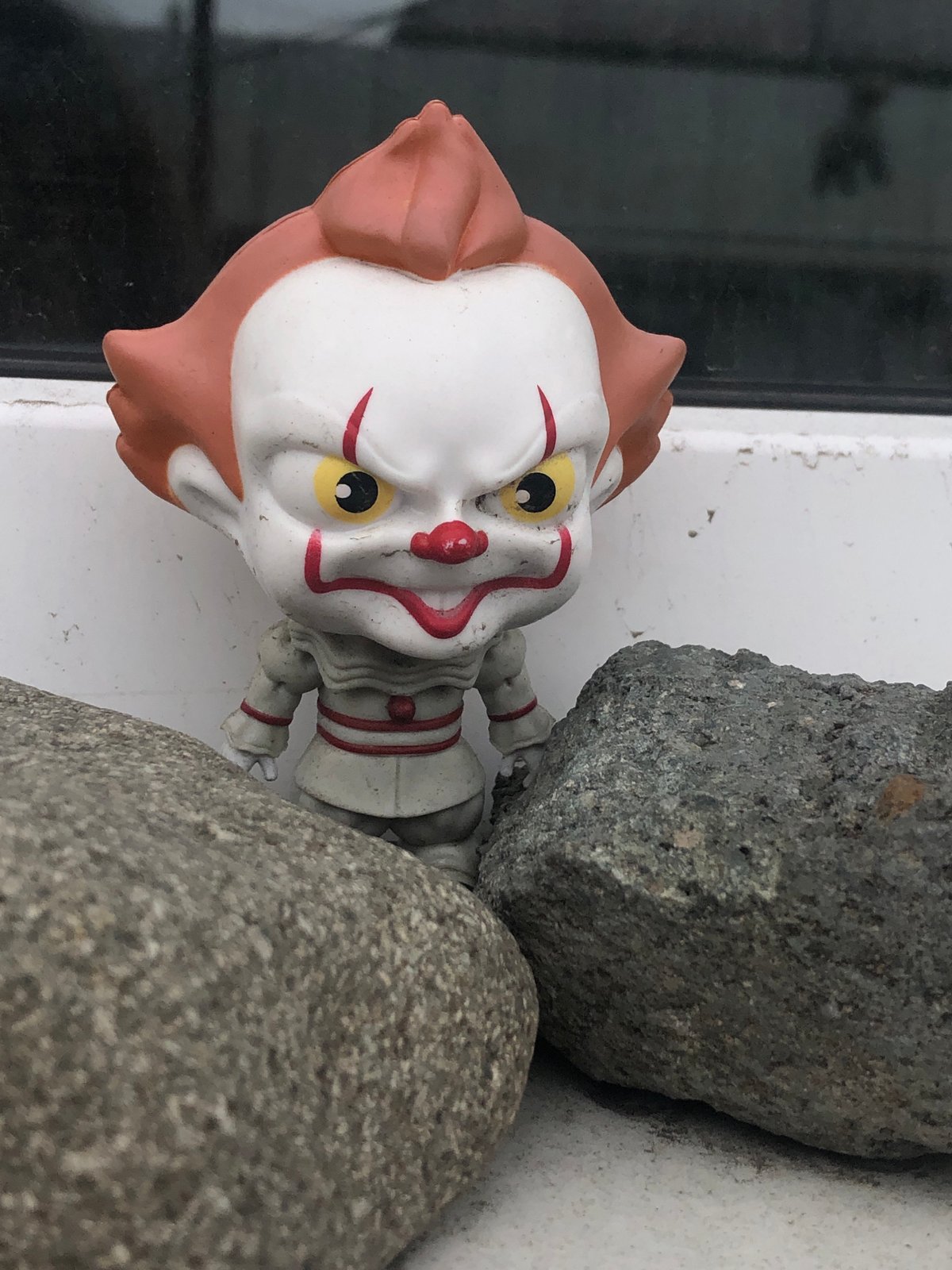 Grey cat and Pennywise figurine share the frame in Yelizovo
