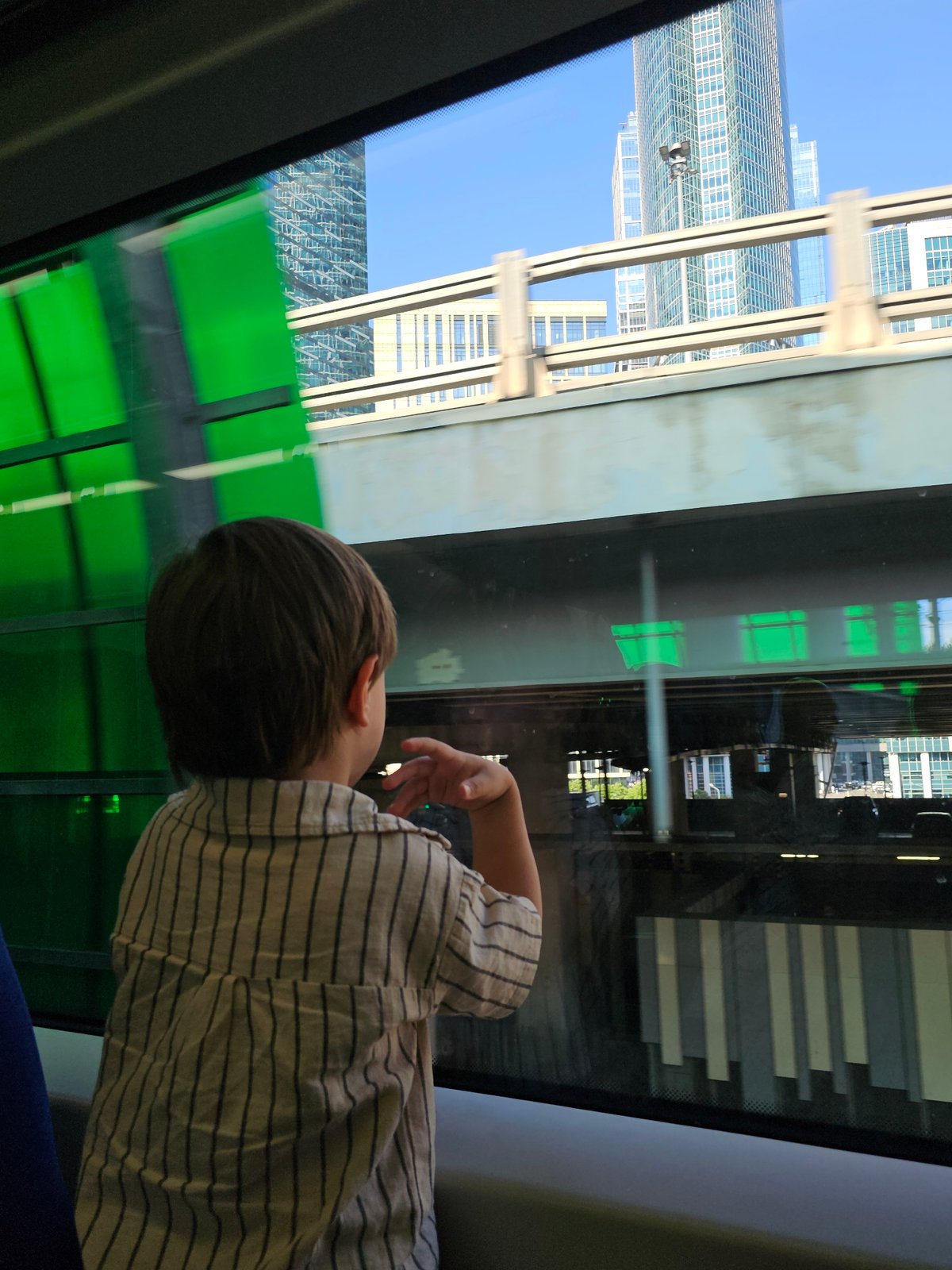 Dozing off on a Moscow train, striped shirt, city rolling by