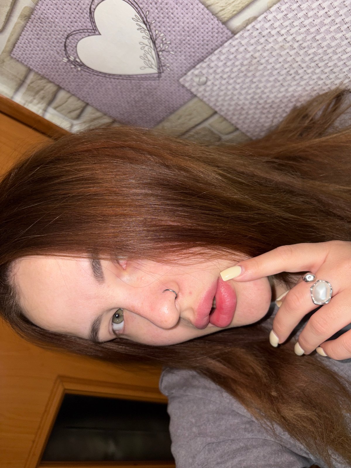 Person with green eyes photographed lying down, looking at camera