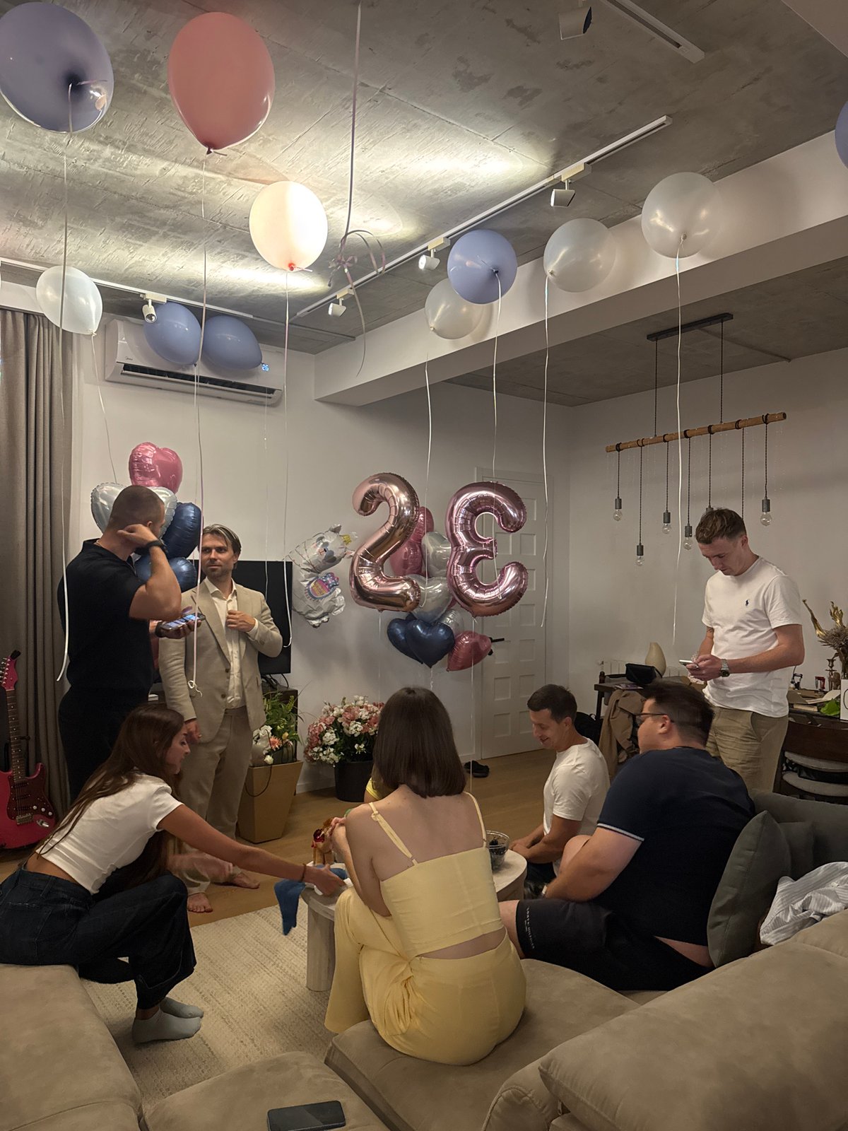 Birthday gathering in a modern Tbilisi apartment, July evening