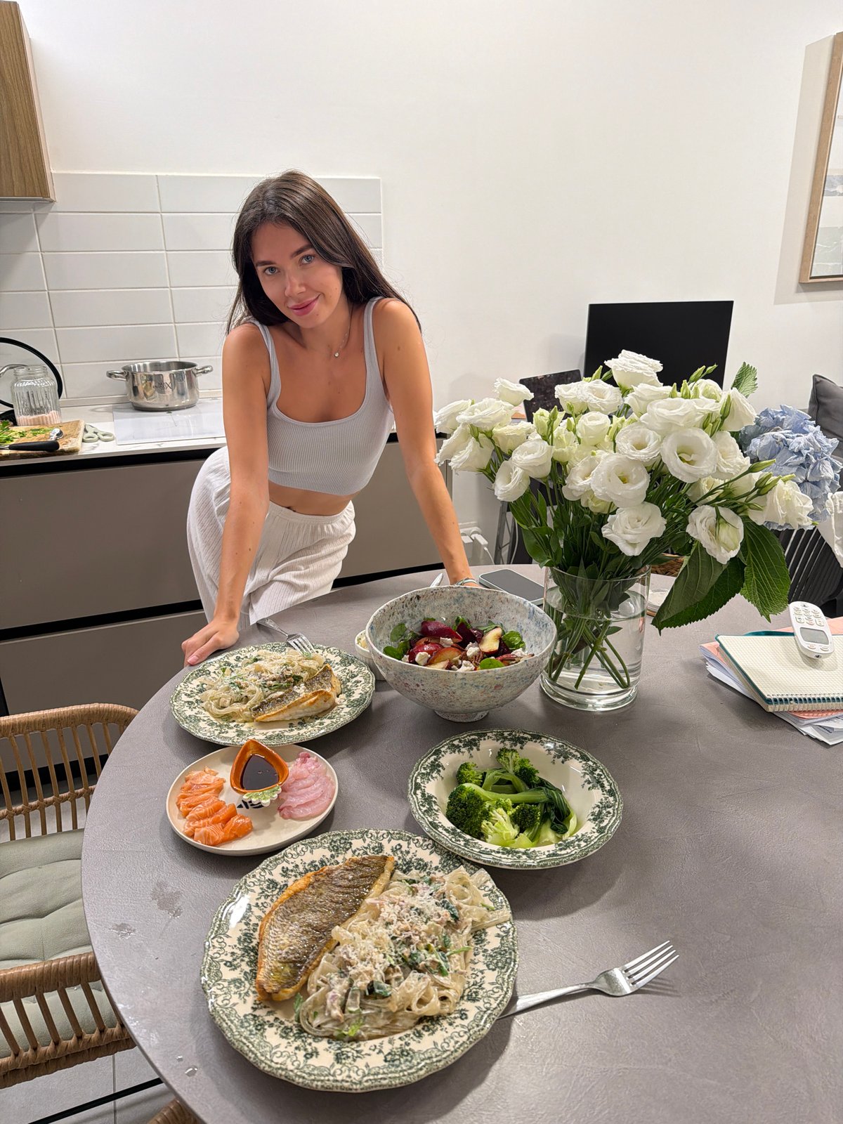 Woman poses by dinner table in Tel Aviv home
