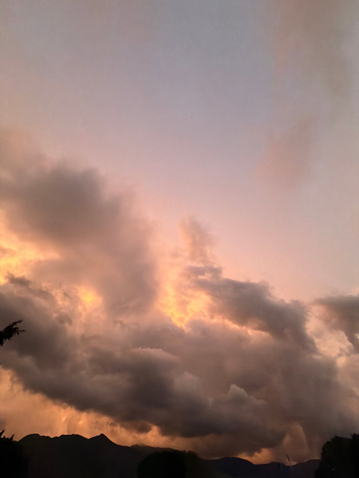 Dramatic sunset colors illuminate cloudy skies over El Cambur, Venezuela
