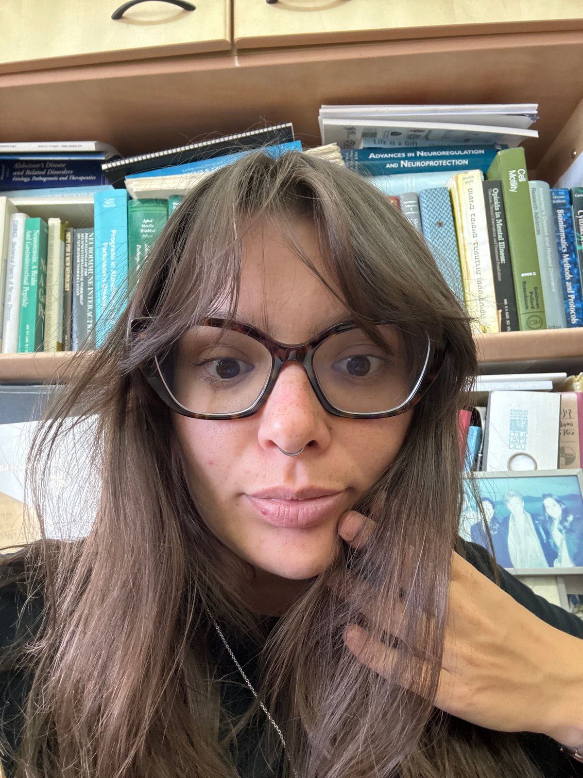 Candid office moment in Tel Aviv with selfies and desk clutter