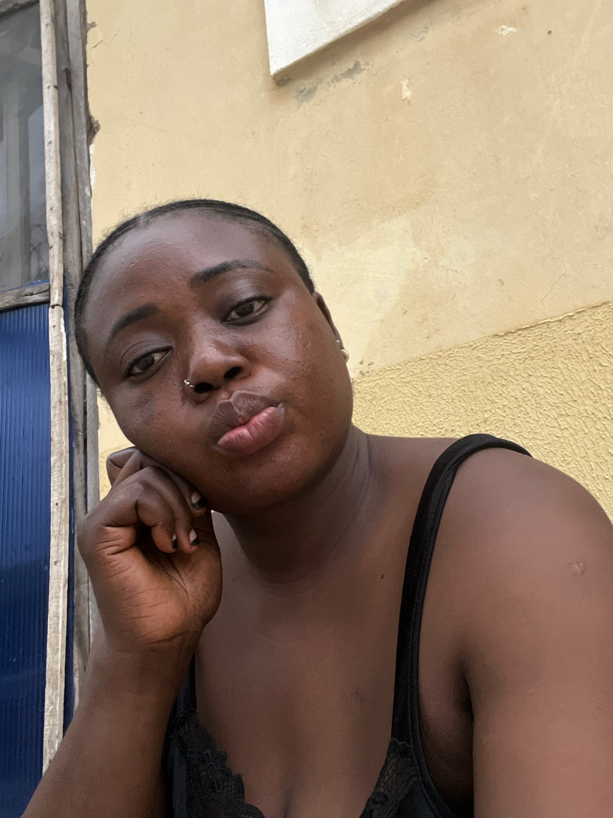 Woman photographed in multiple poses around Abuja residence