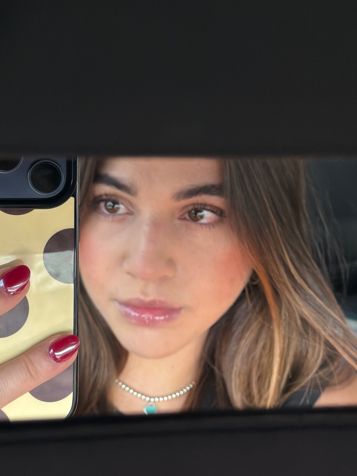 Woman takes selfie in car mirror in Mexico