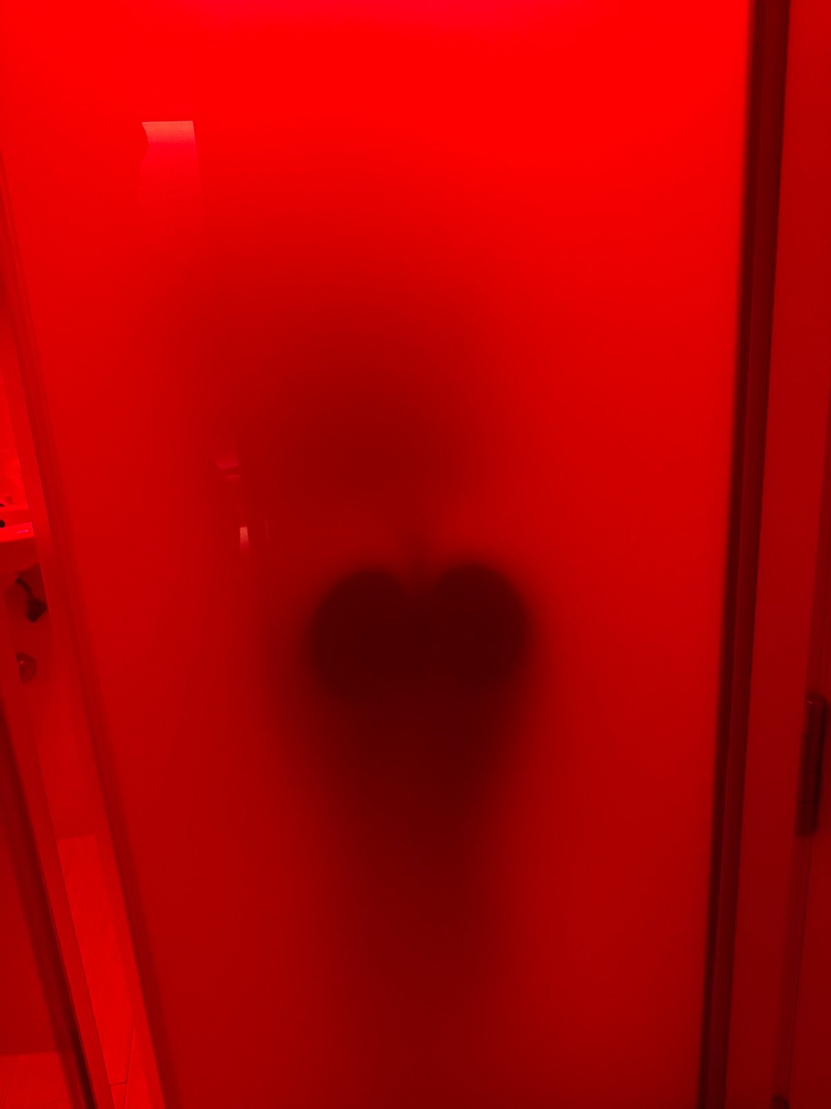 Red glass, shadows, and nighttime Madrid streets