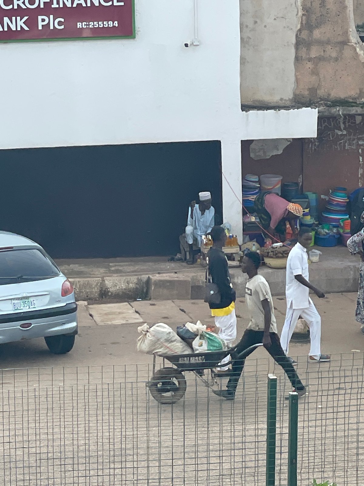 Midday street and market activity in a busy urban African setting