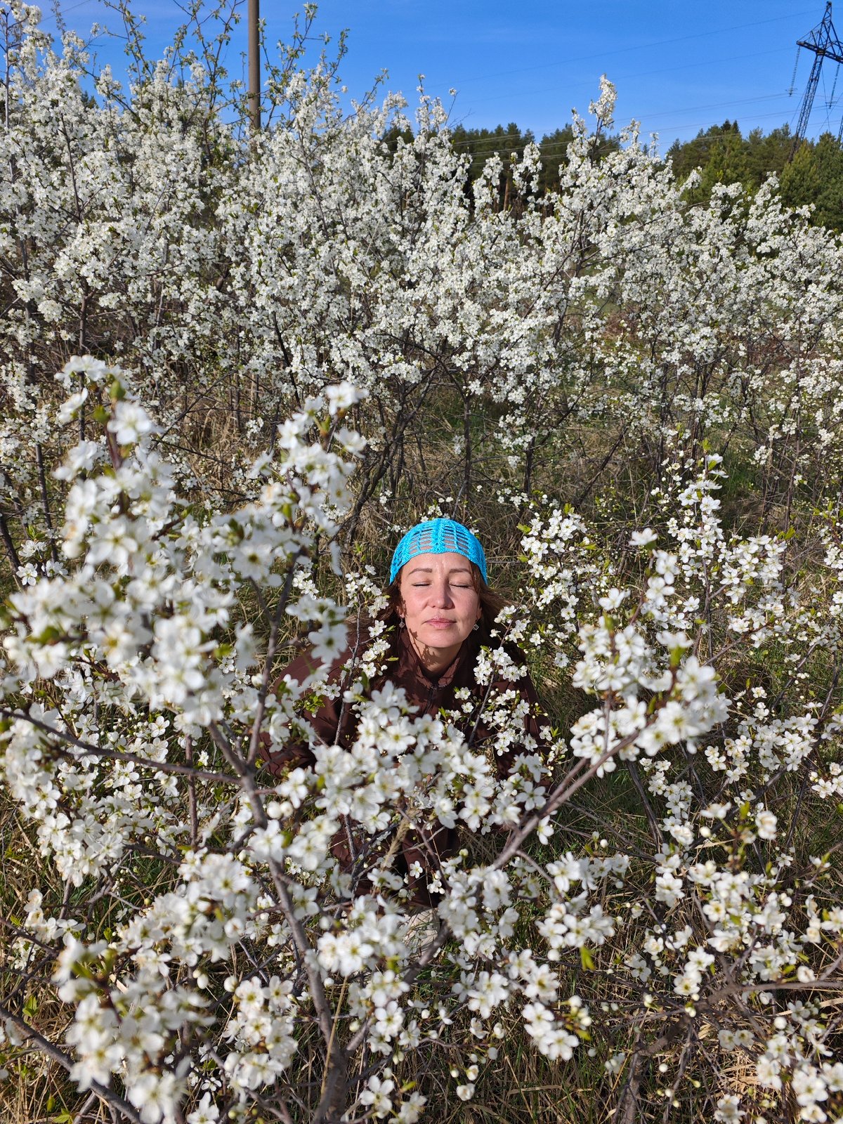 Women enjoy spring blossoms in Chaikovsky, Russia