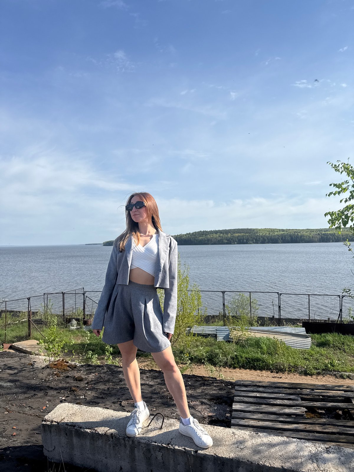 Woman poses for photos along Kama River in Chaikovsky