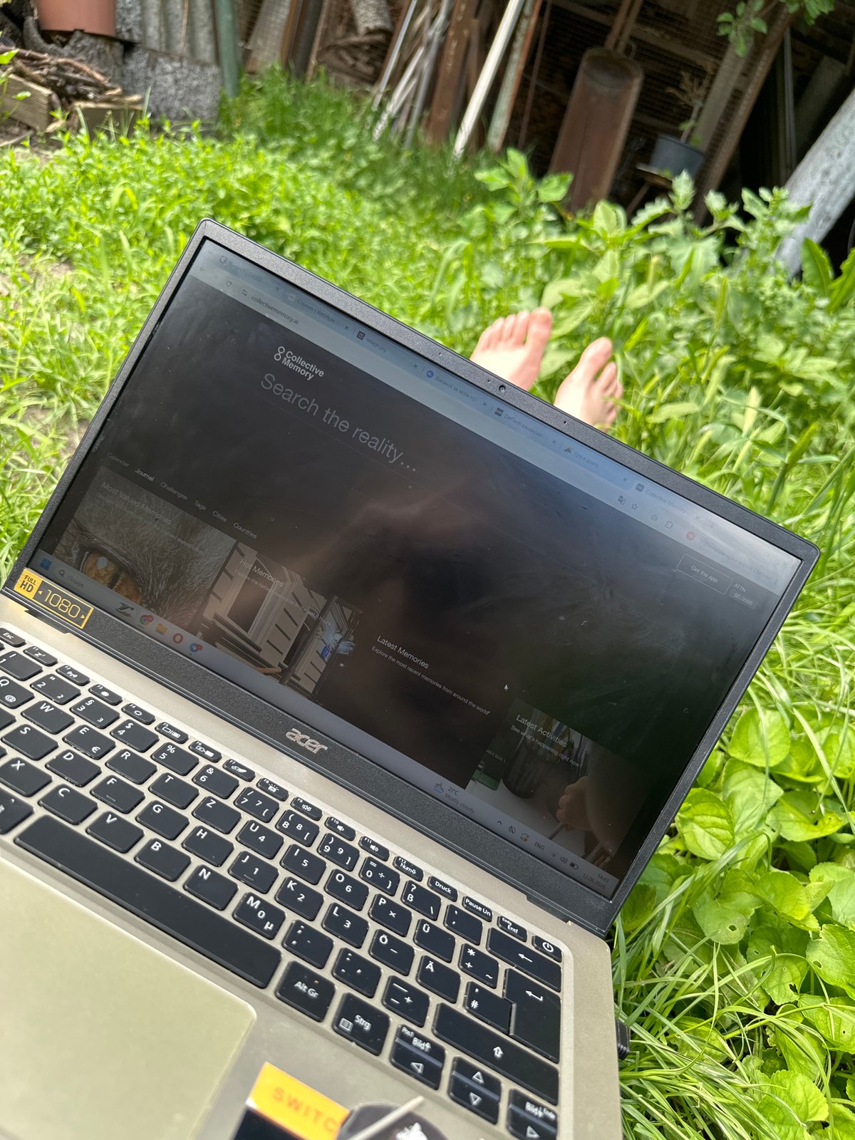 Laptop displaying Collective Memory website found on grass
