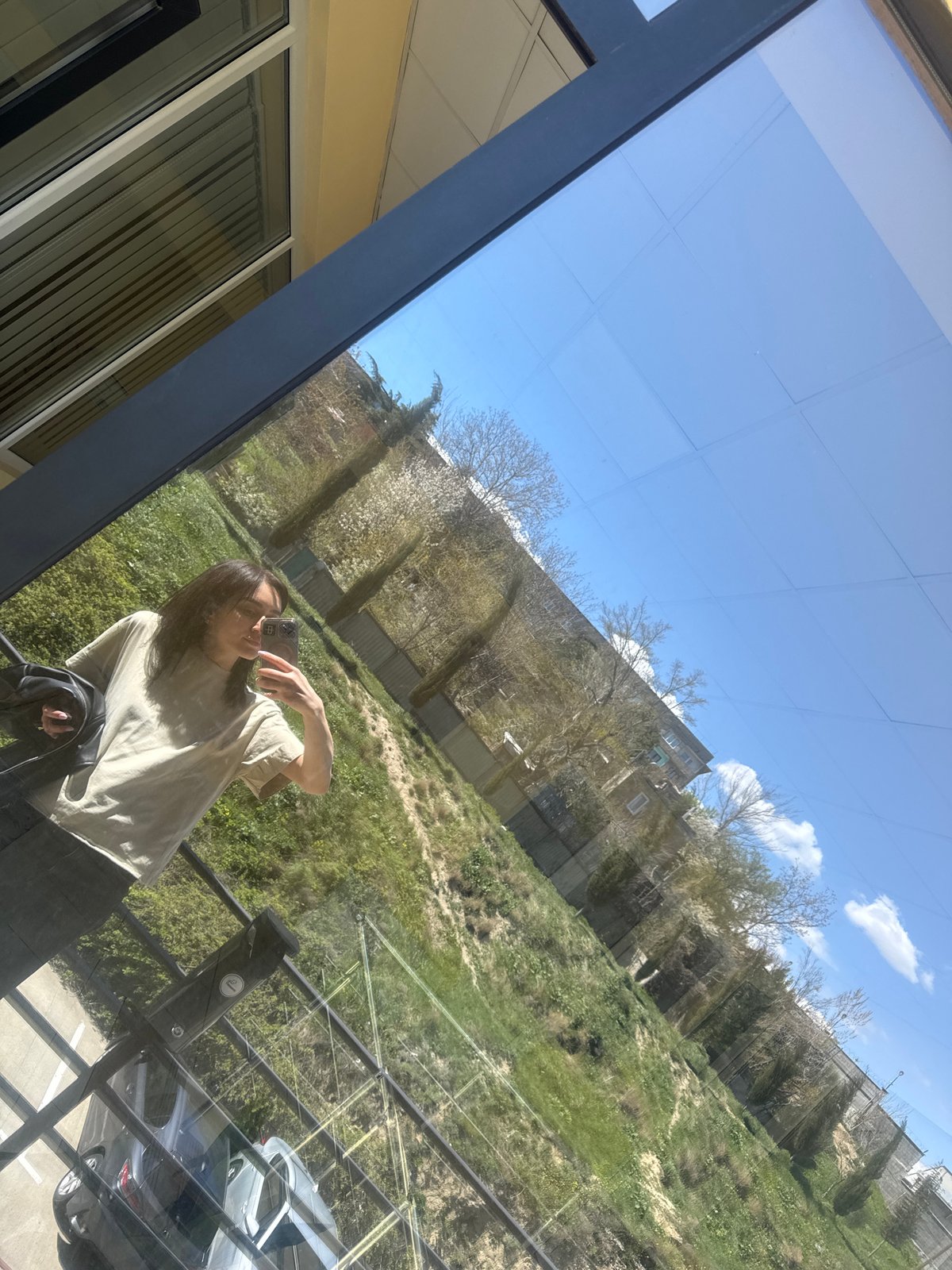 Woman takes selfies overlooking Tbilisi cityscape from building