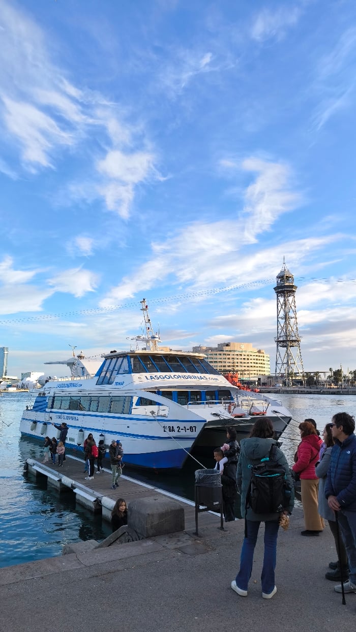Barcelona waterfront buzzes with tourists, street performers, monument visitors