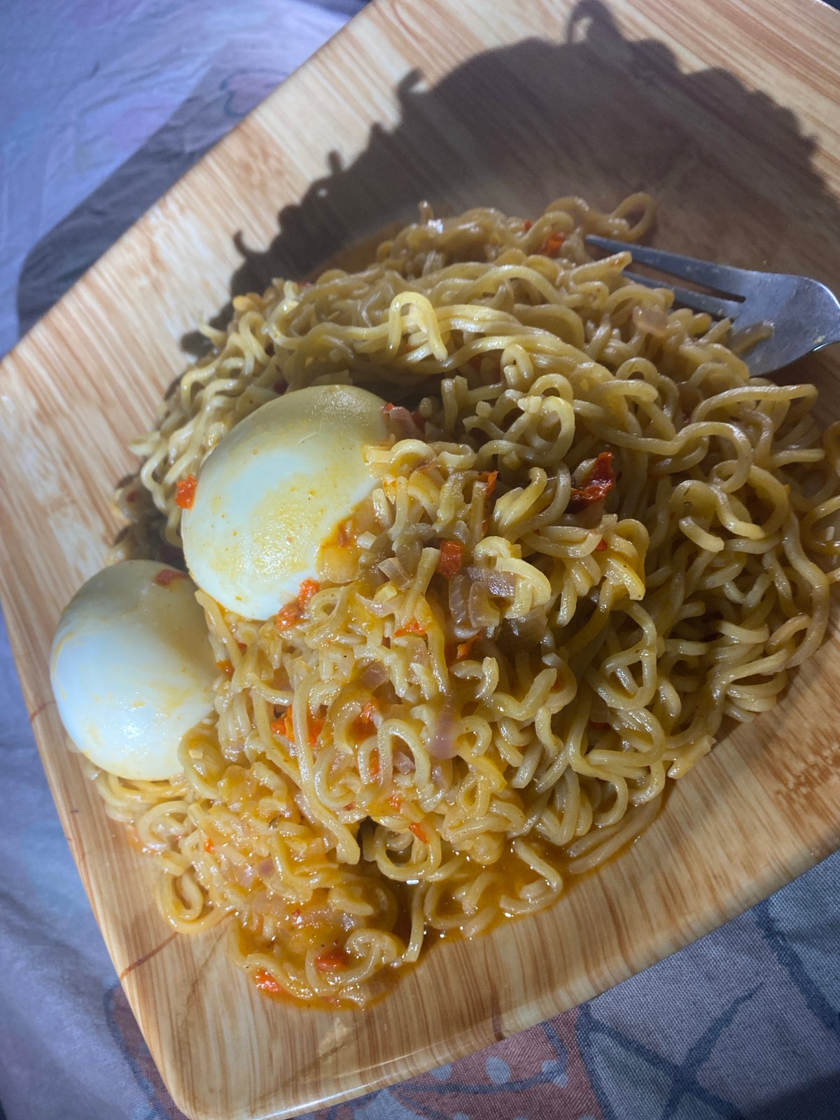 Instant noodles and eggs for a late-night meal in Abuja