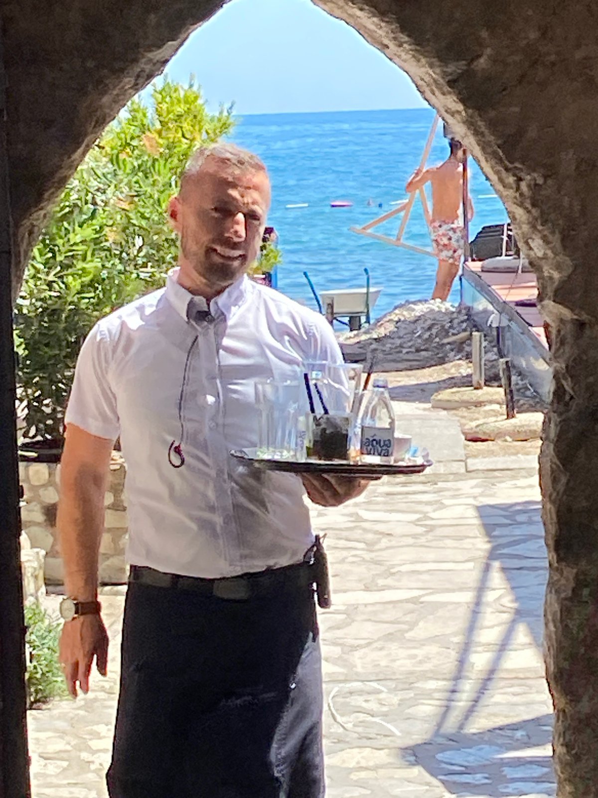 Tourist explores historic Budva Old Town and coastline