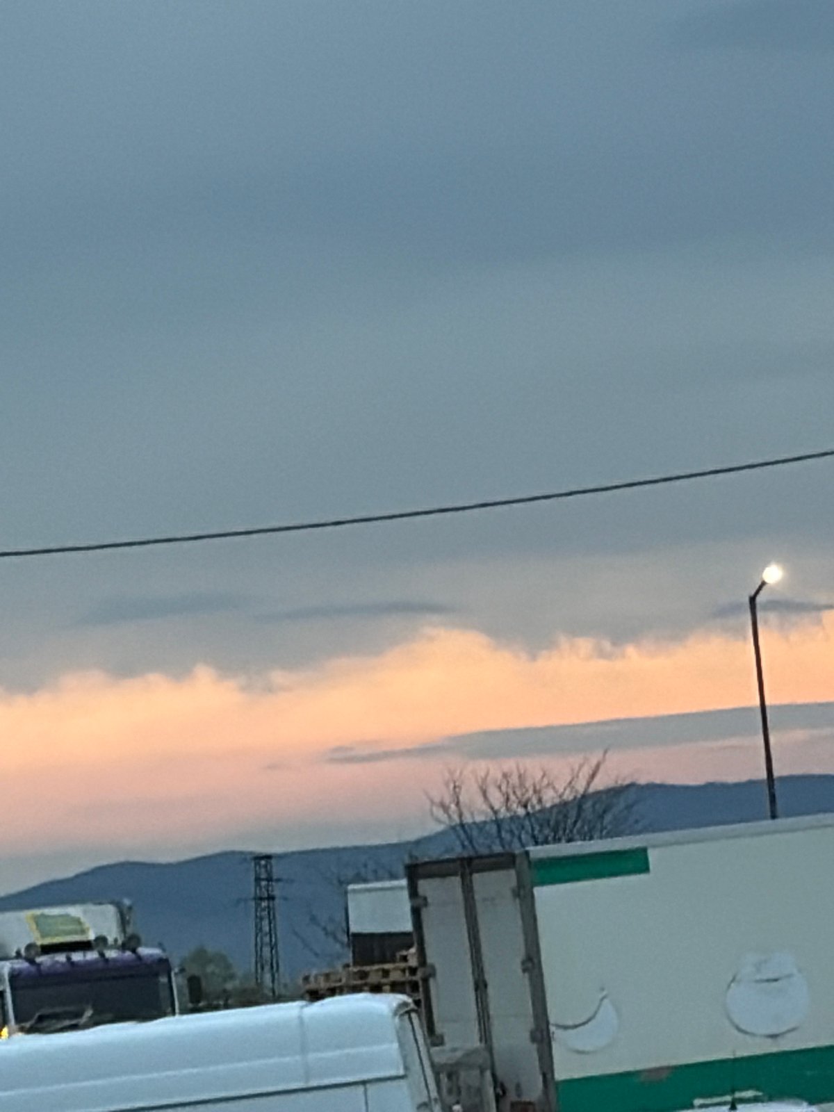 Sunrise or sunset sky captured over industrial landscape