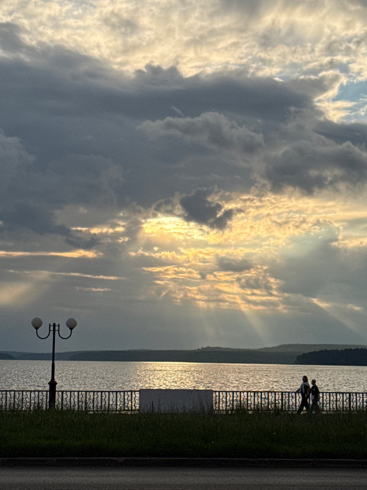 Golden sunset over Votkinsk waterfront, clouds and a cat