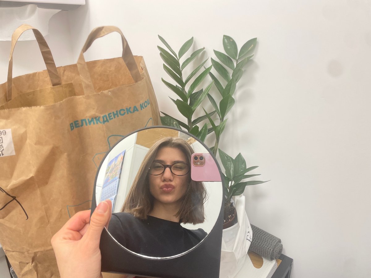 Woman tries on glasses at Sofia eyewear store