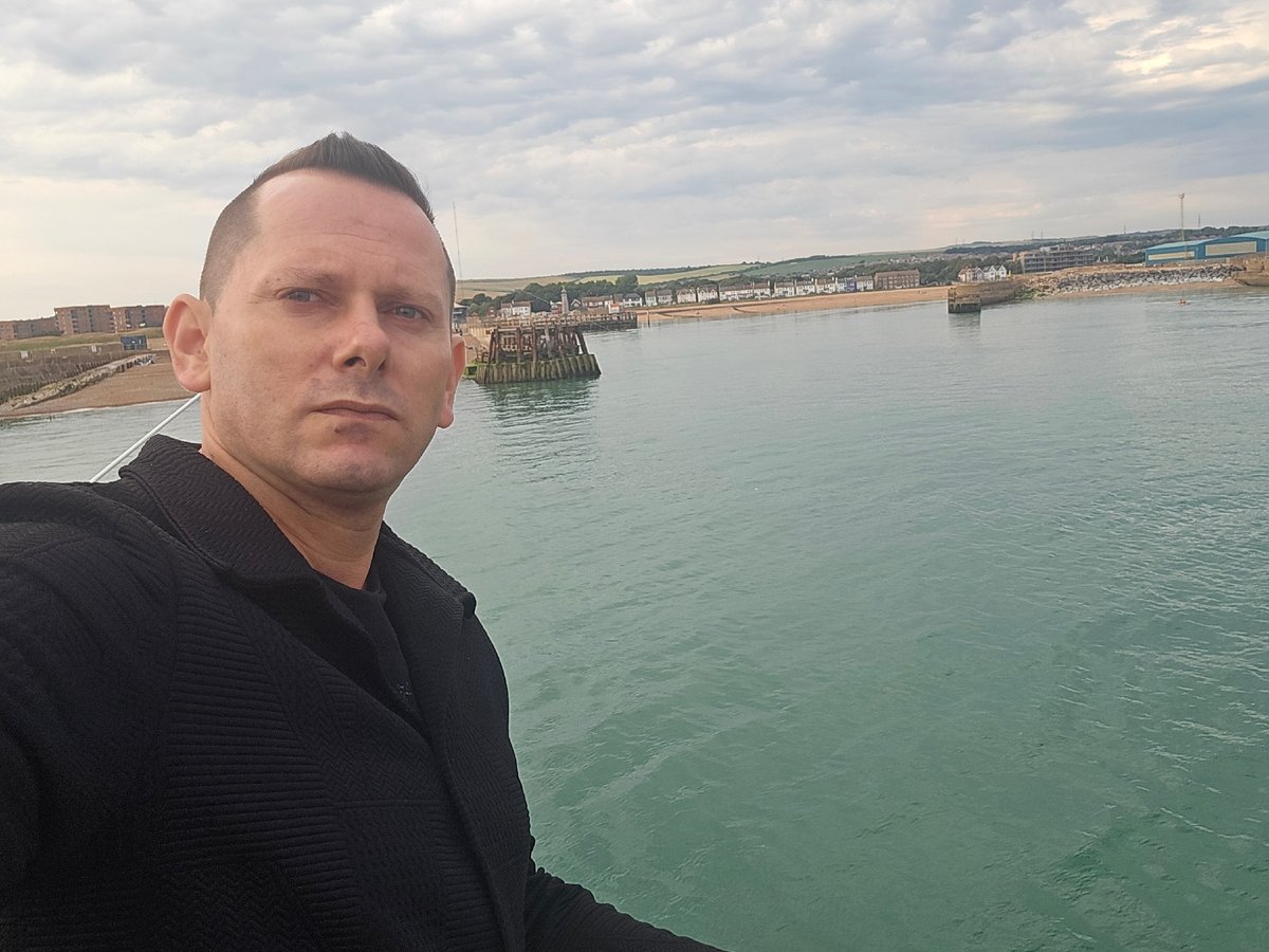 Selfies and fishing on an Adur pier, cloudy afternoon