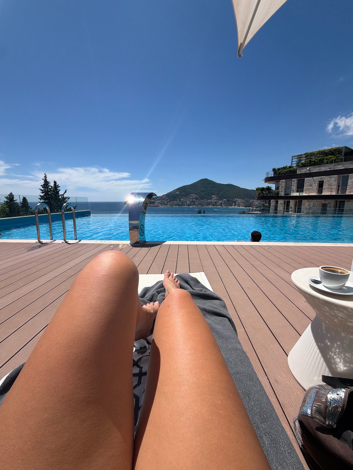 Poolside relaxation at Montenegro infinity pool overlooking Adriatic Sea