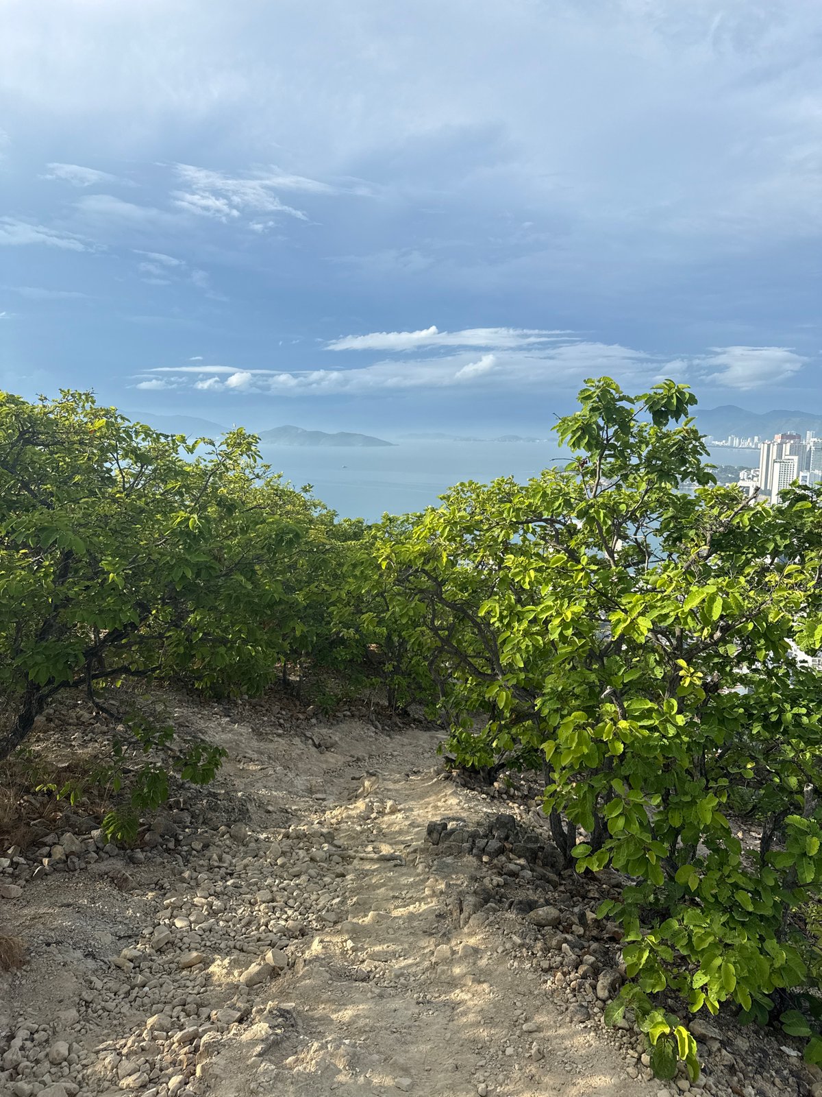 Evening hillside trek documents Nha Trang coastal views, cave exploration