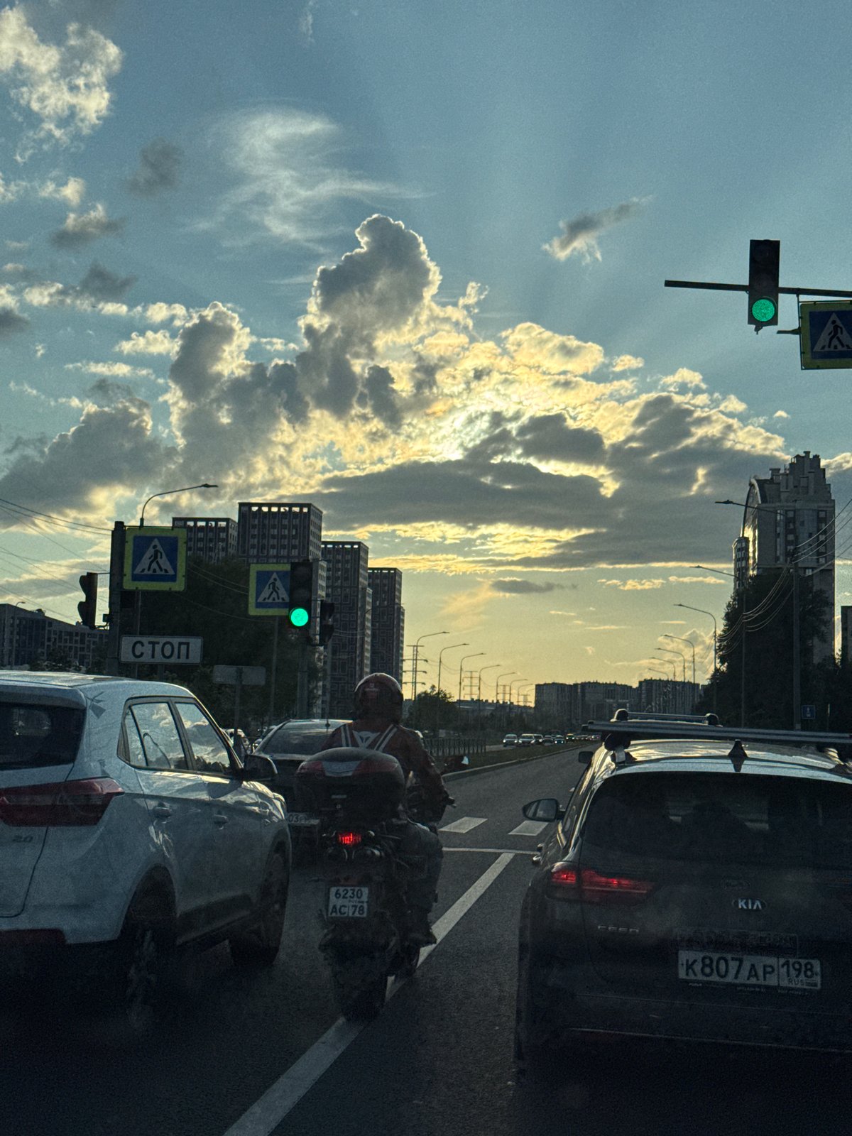 Saint Petersburg traffic under a golden late-afternoon sky