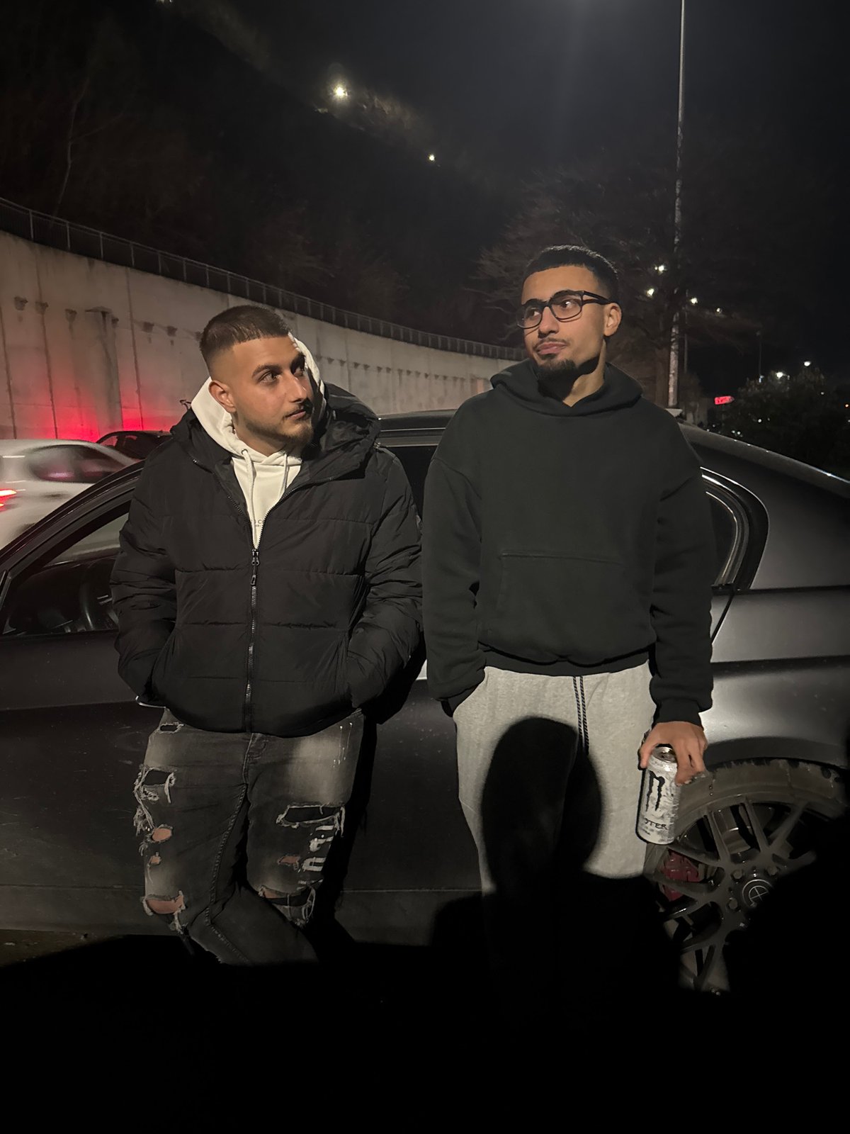 Two men pose for photo near car in Varna