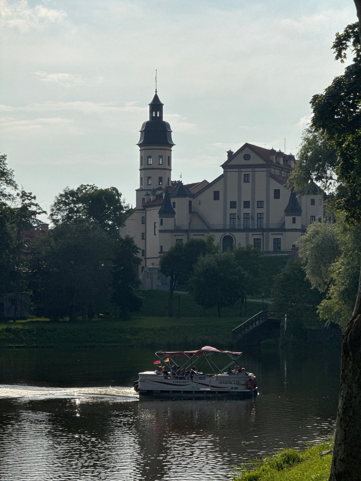 Afternoon at Nesvizh Castle: grounds, lake, and an outdoor event