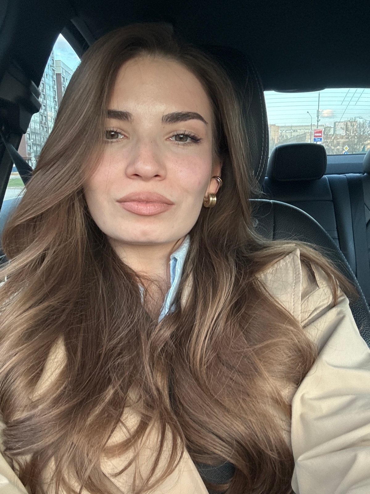 Woman in light coat observed in car in Moscow