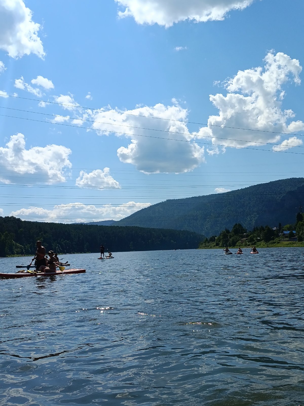 Summer day on the river at Усть-Мана — paddleboards, boats, and cliff jumpers
