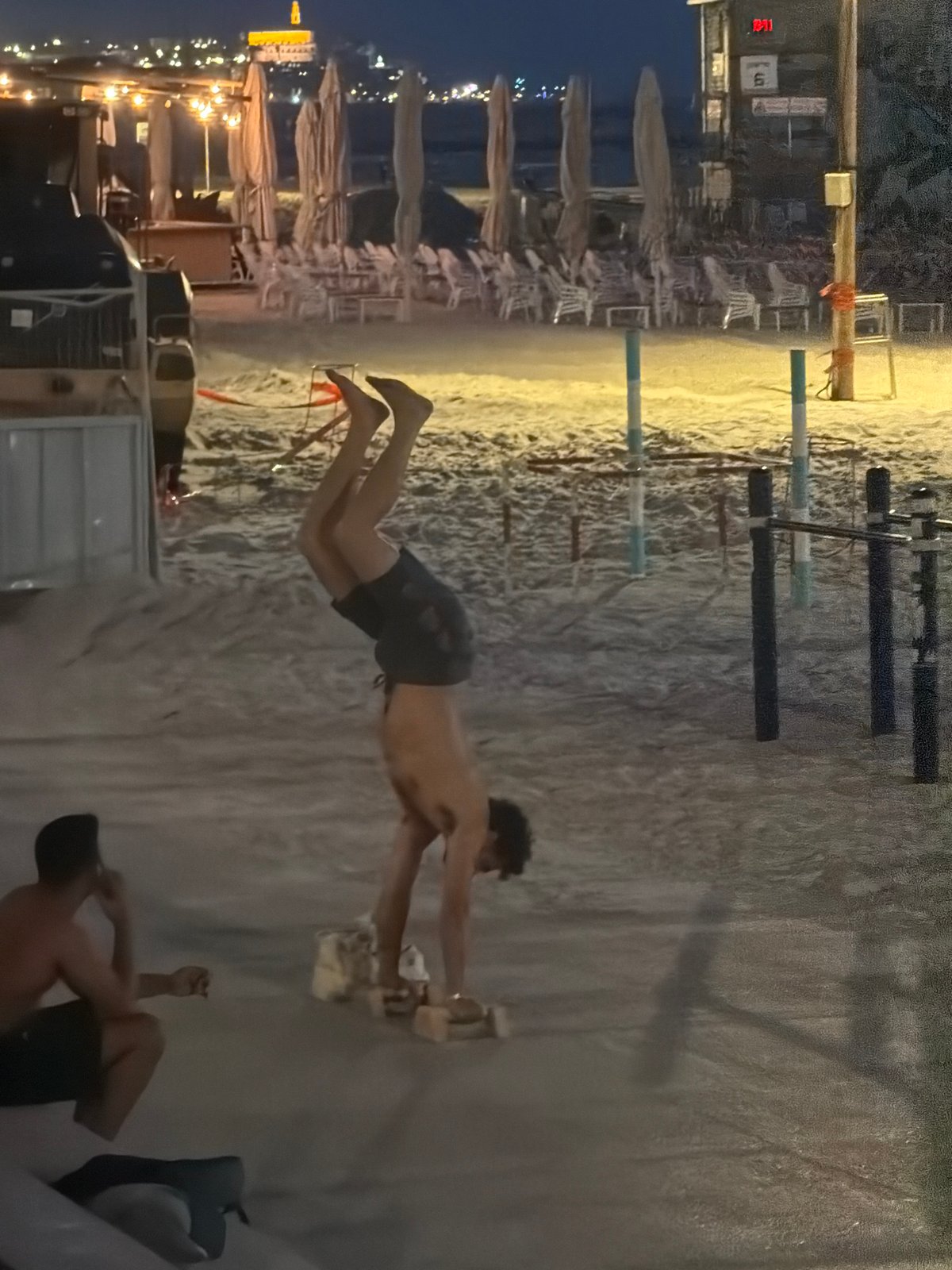 Tel Aviv beachfront captured at dusk with city skyline