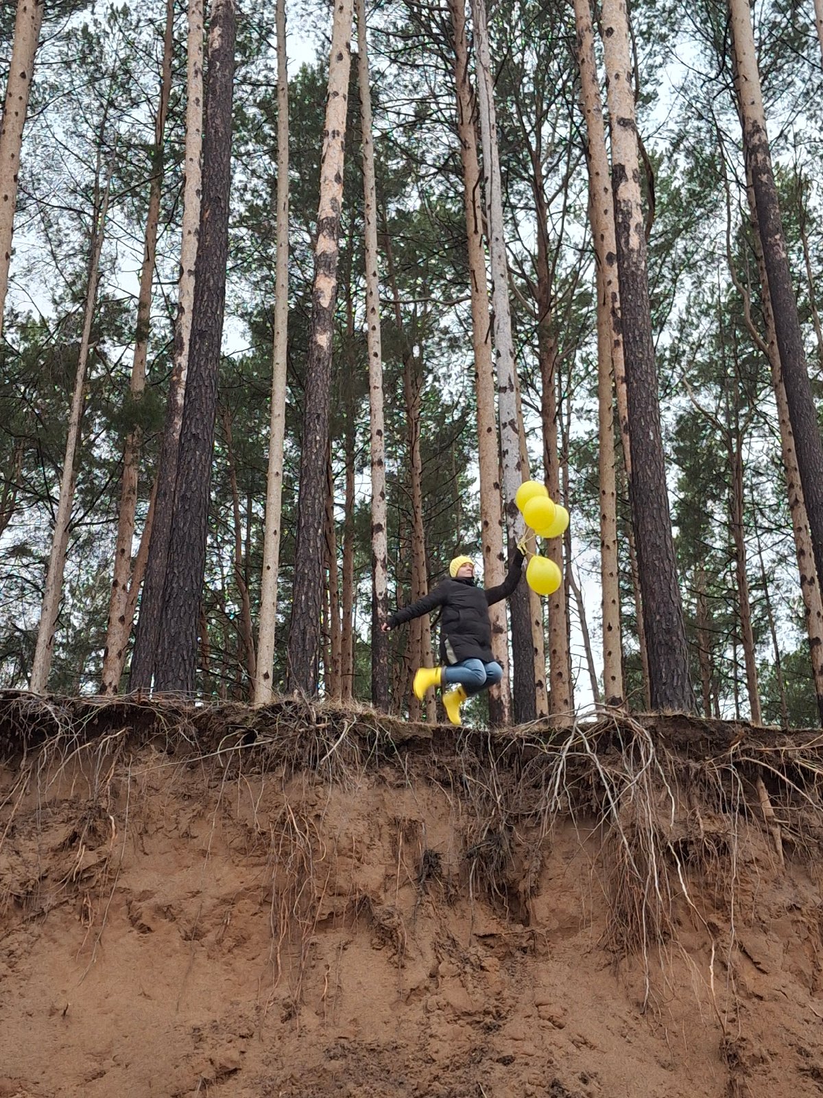 Person with yellow balloons enjoys afternoon outing in Chaikovsky