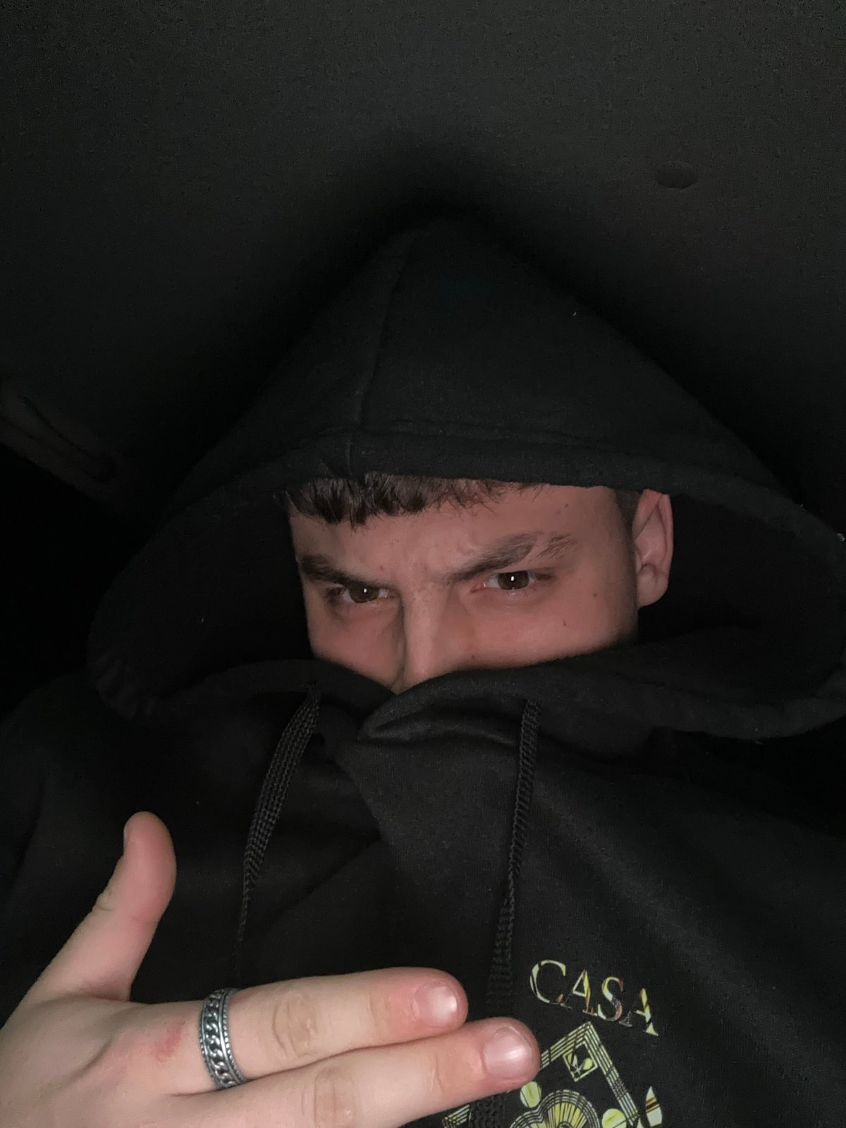 Nighttime street photography captures hooded figure in Devin, Bulgaria