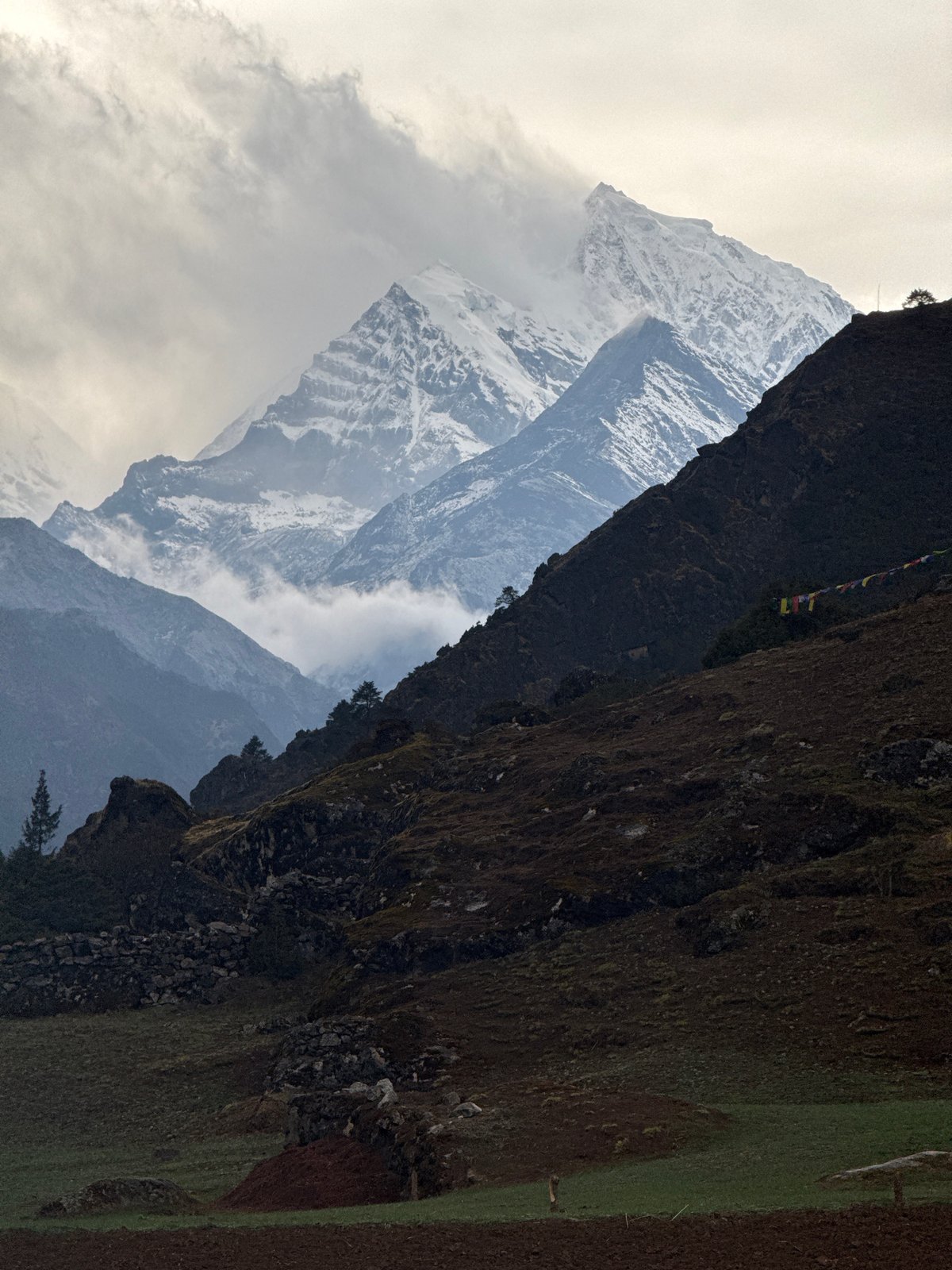 Mountain vista with prayer flags observed in Namche, Nepal