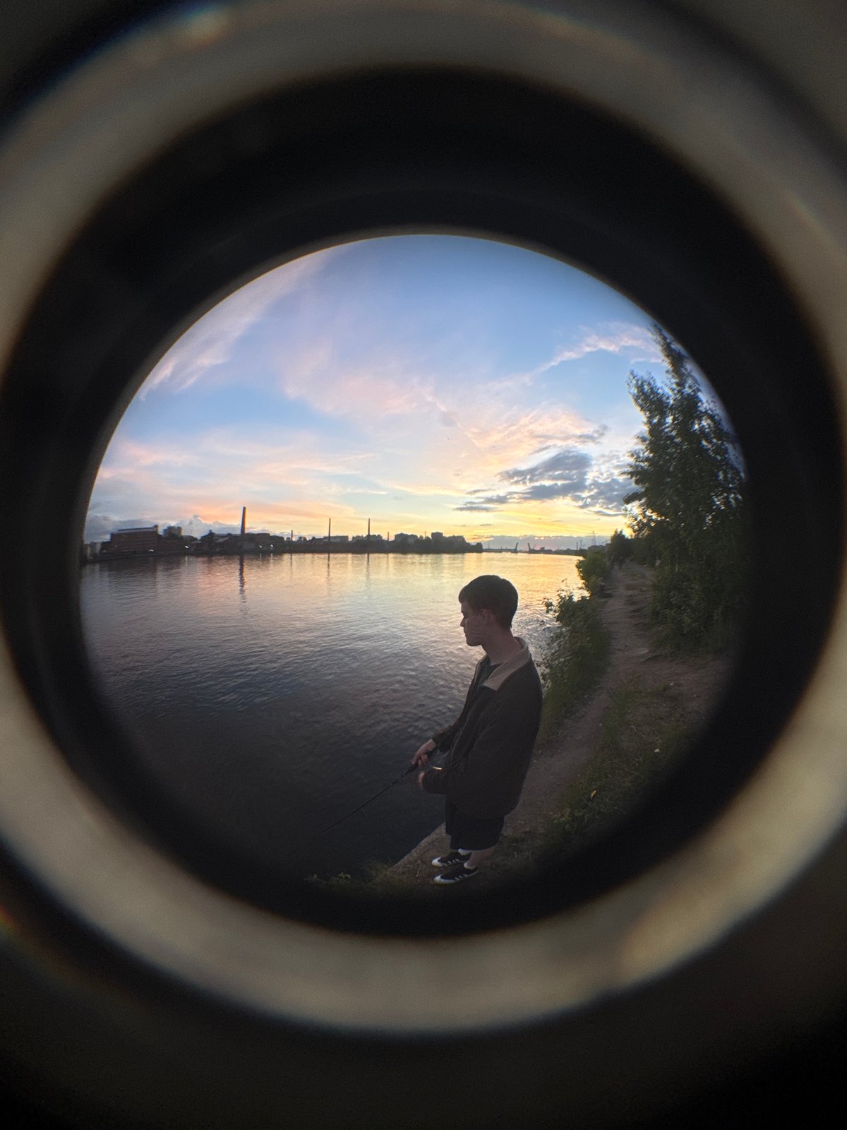 Fishing at sunset on the Neva River embankment, Saint Petersburg