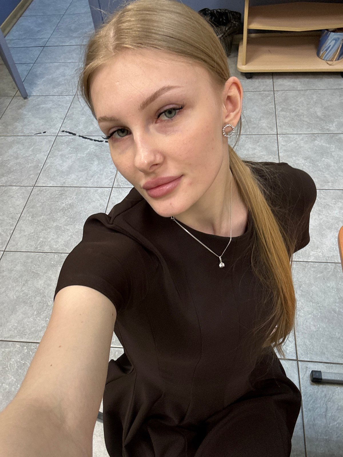 Woman takes playful selfies in Perm office building