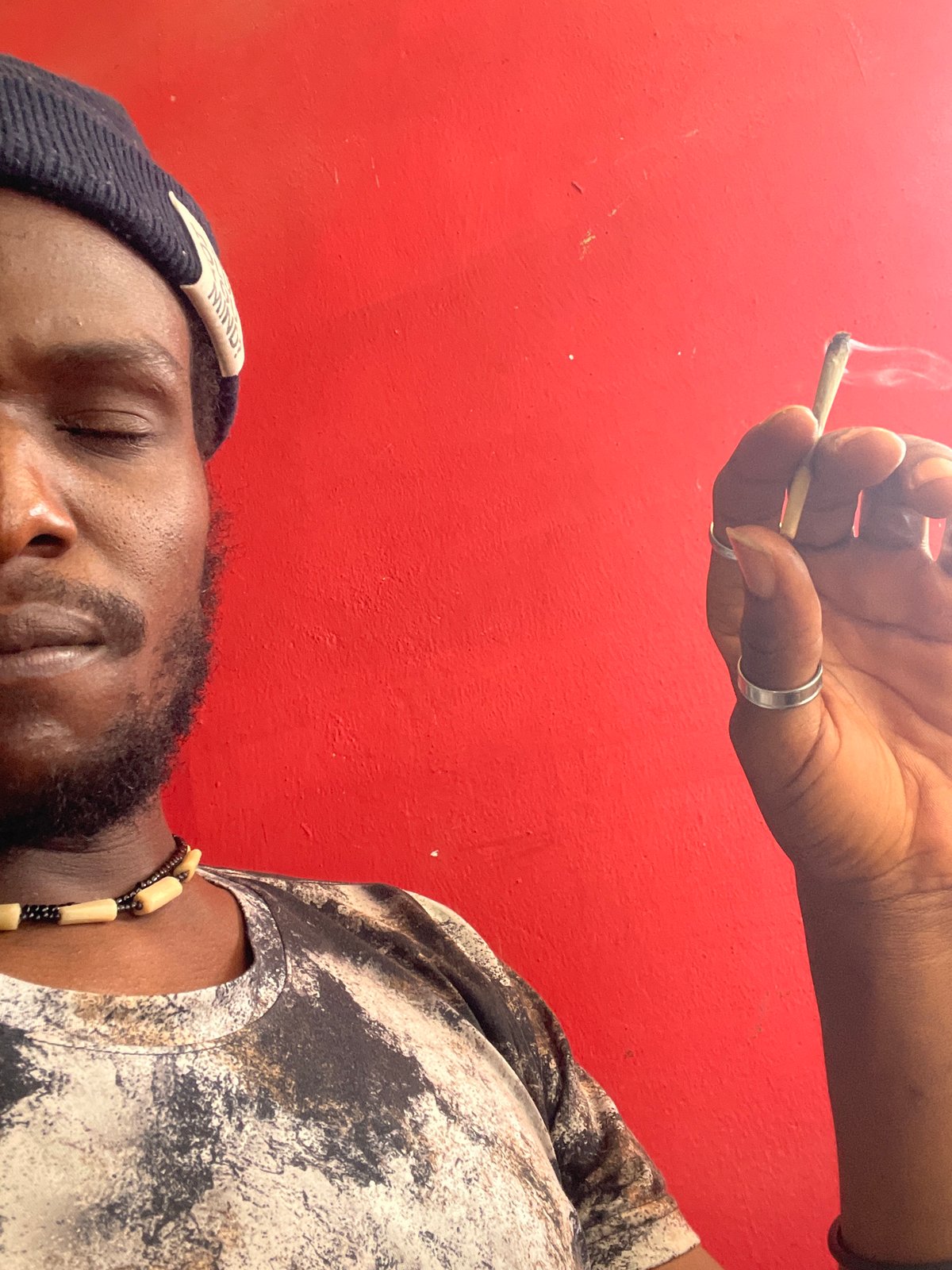 Person rests while cigarette held overhead in Jos