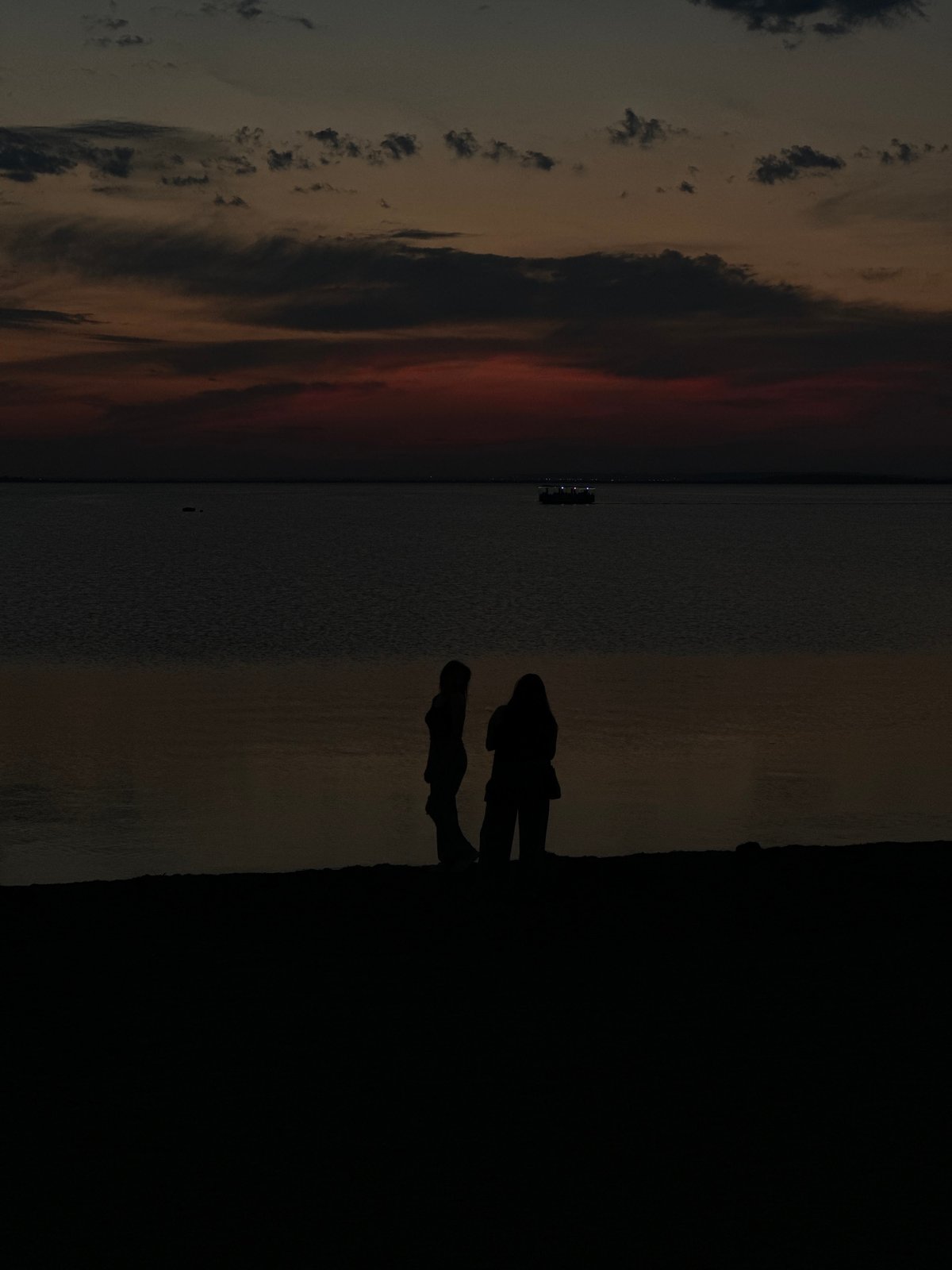 Kokshetau waterfront at golden hour, landmarks lit up