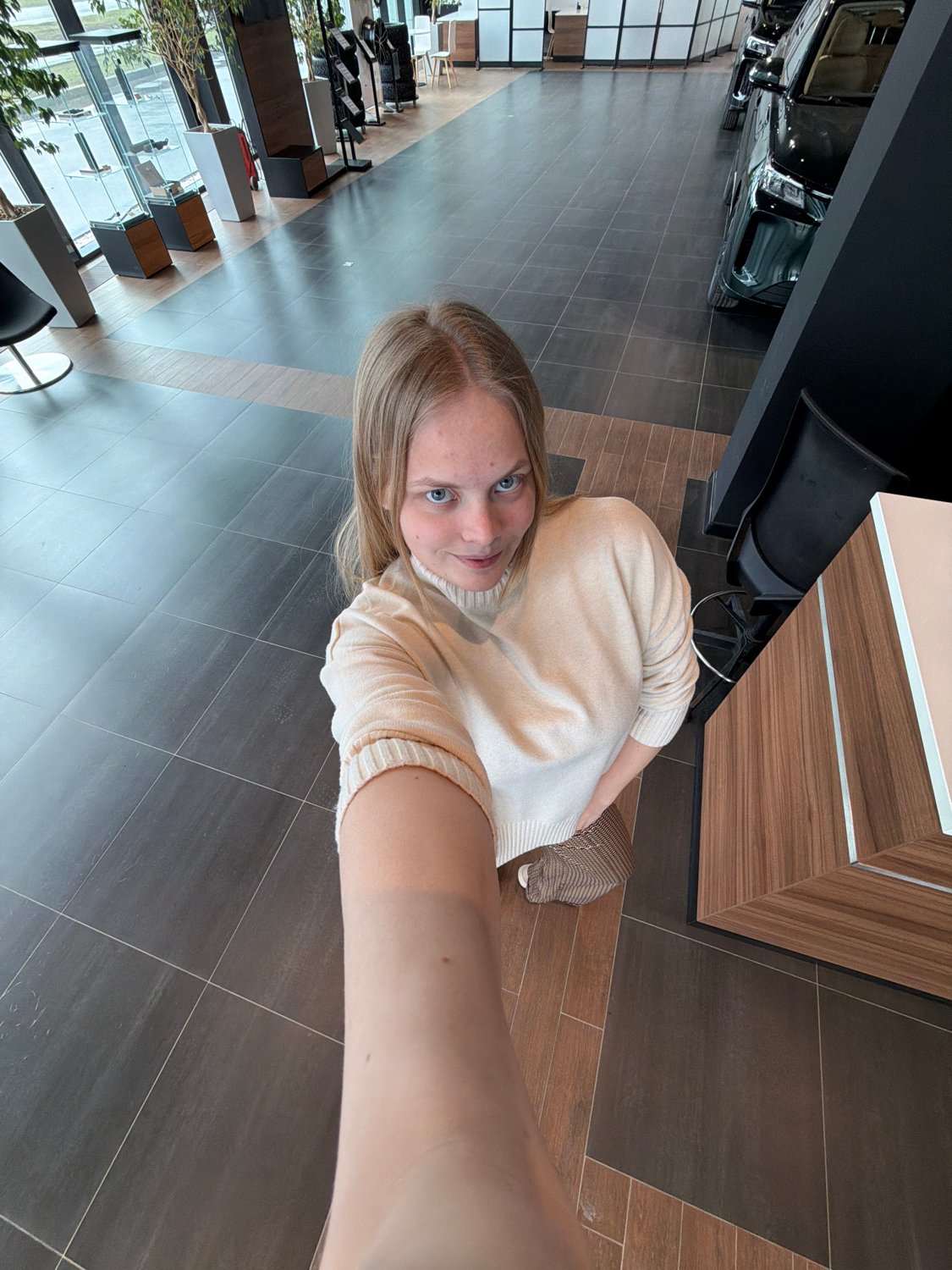 Woman takes selfies at multiple indoor locations in Izhevsk