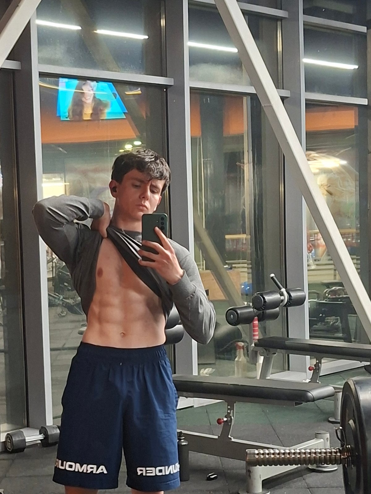 Young man takes mirror selfies at Plovdiv gym