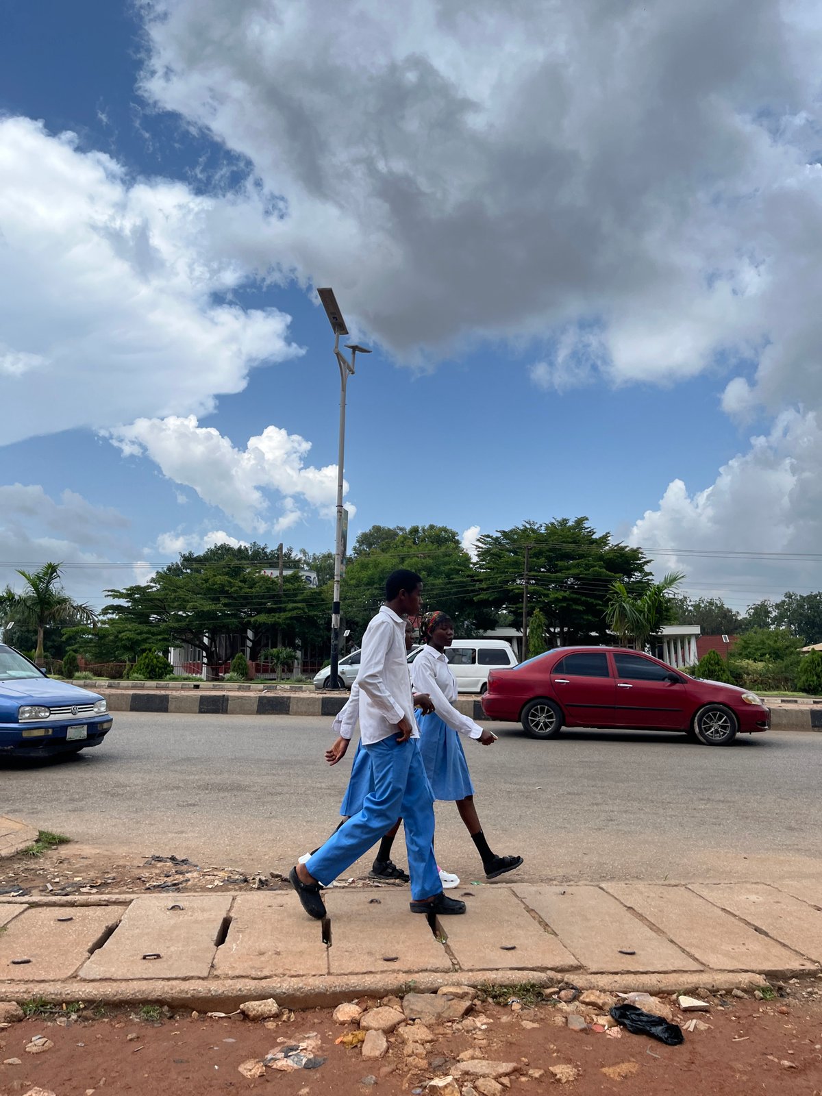 Busy afternoon streets in Jos, Nigeria, with school groups and street traffic
