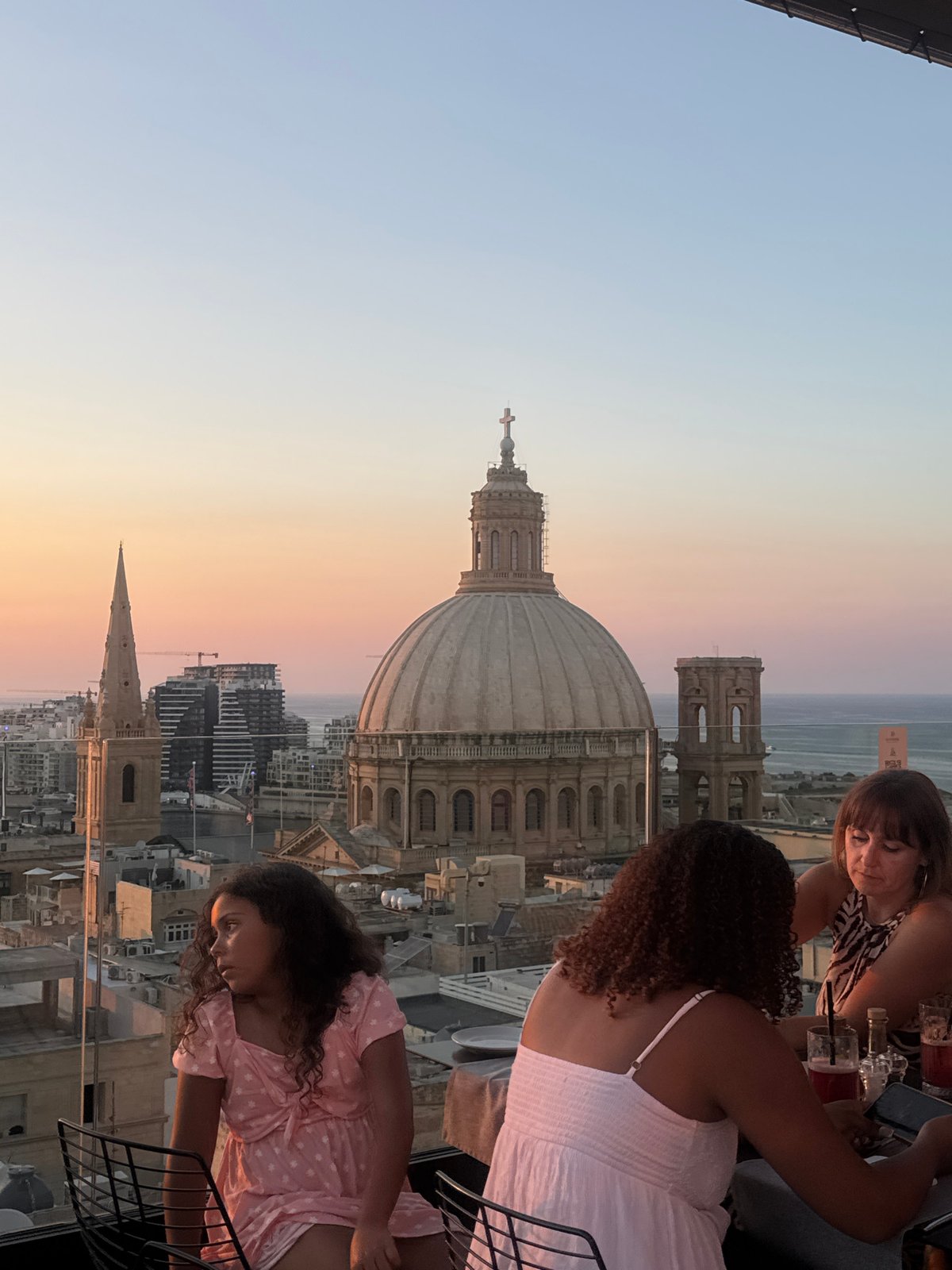 Rooftop sunset views over Valletta from a poolside setting