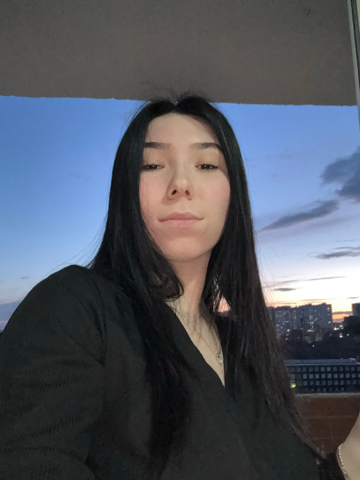 Woman captures quiet evening with cat in Izhevsk twilight