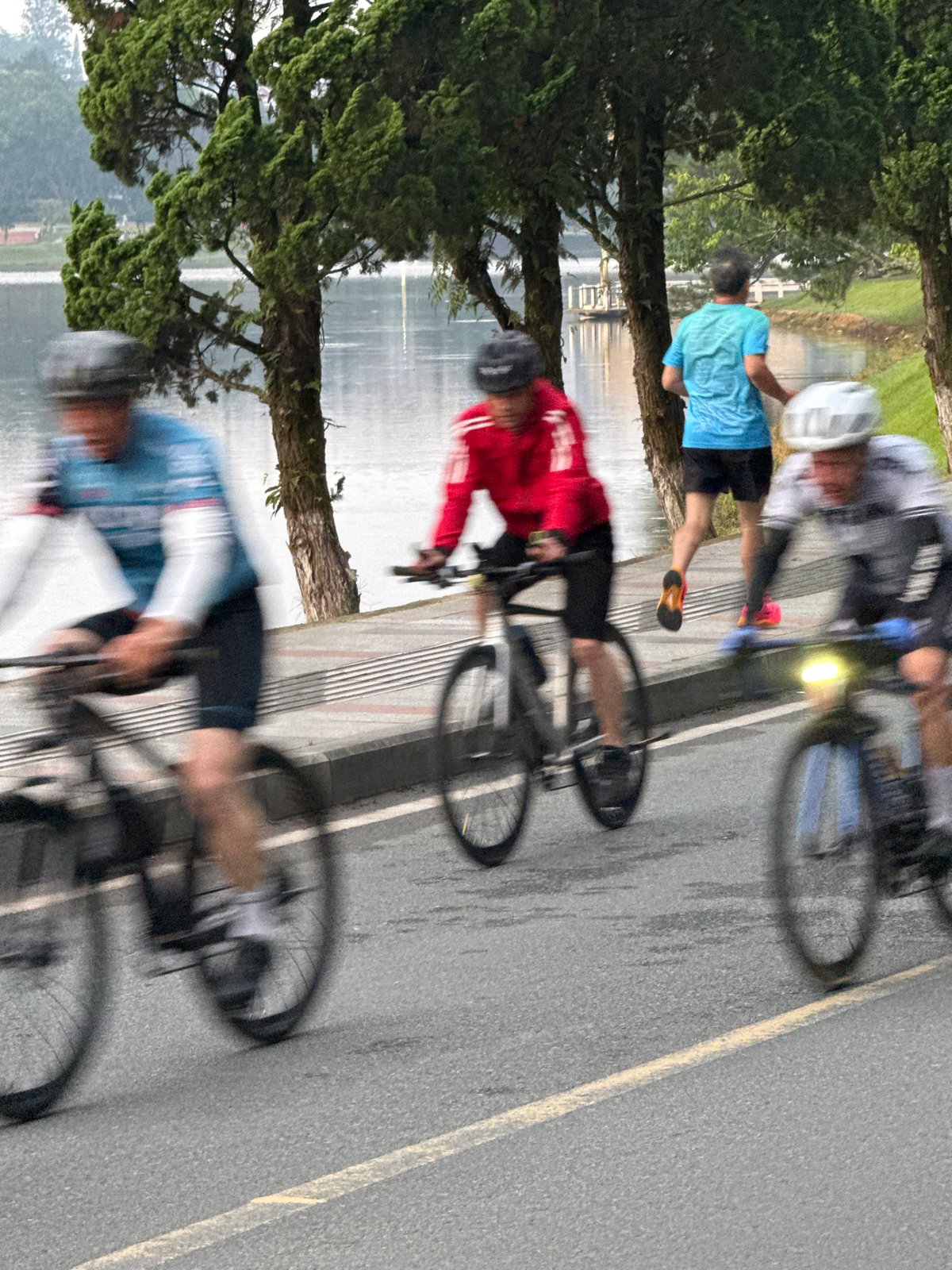Cyclists and walkers circle Xuan Huong Lake in Da Lat