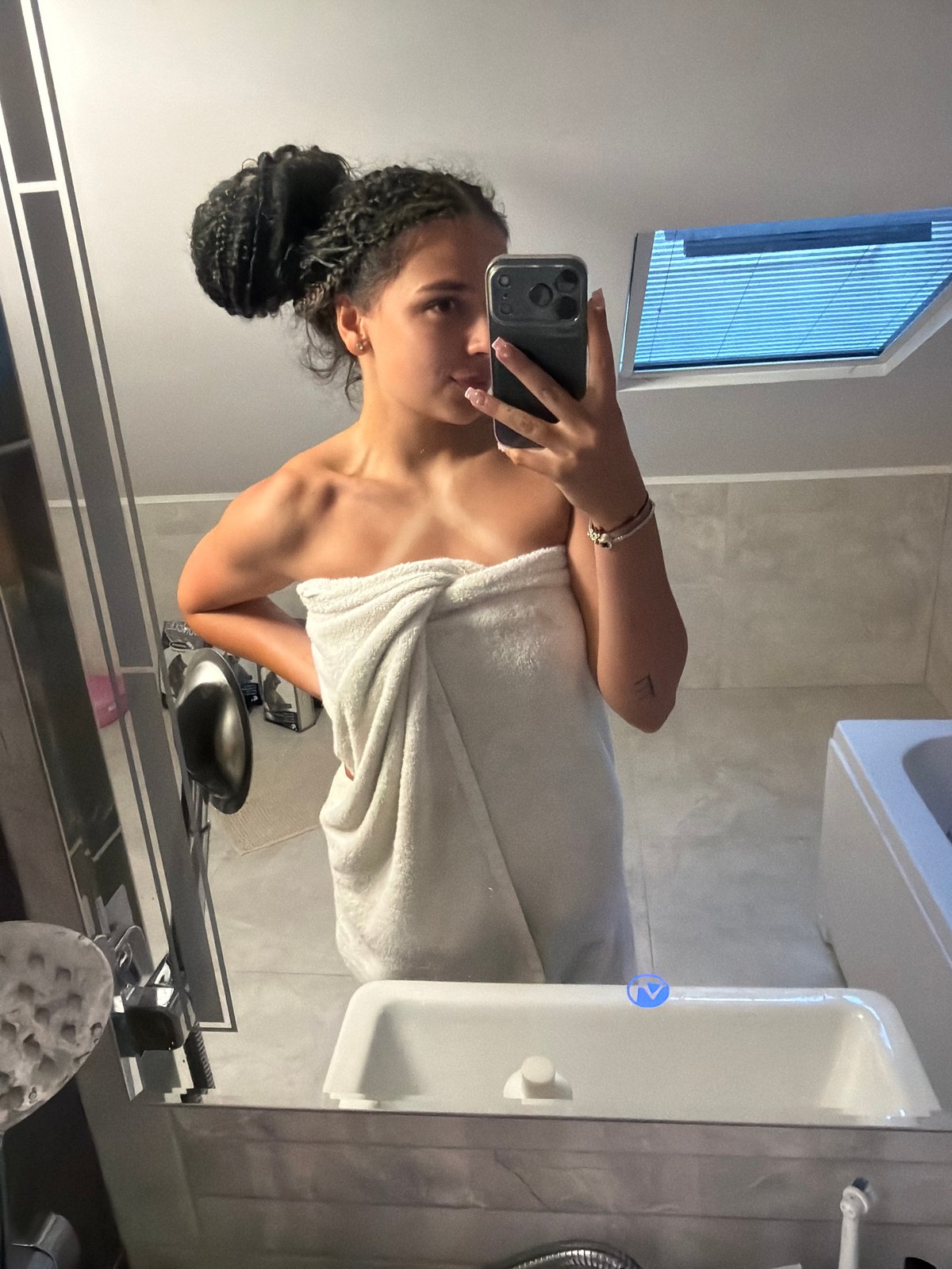 Bathroom mirror selfie in Gabrovo, grey tiles, white towel.