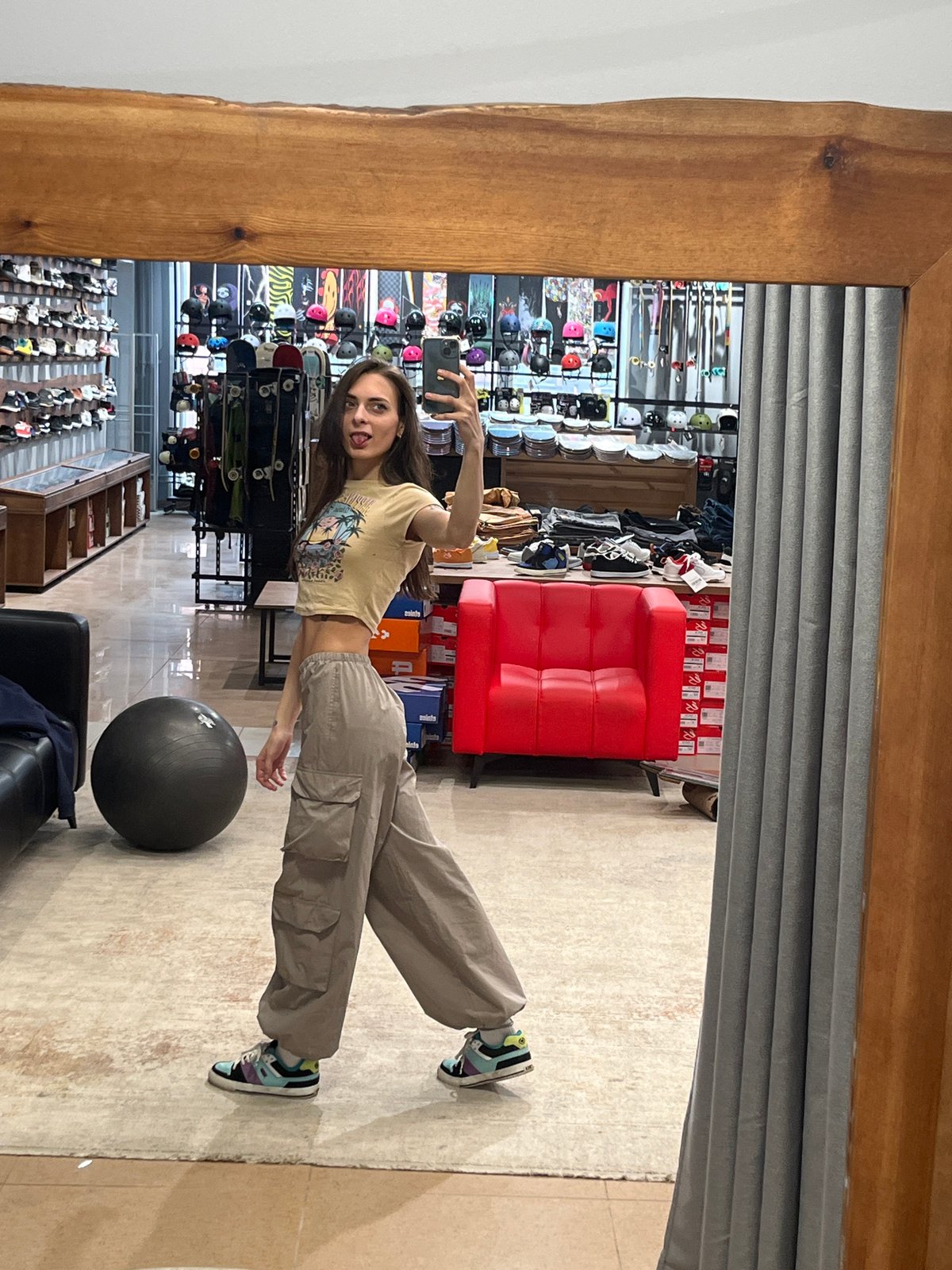 Woman takes mirror selfie at sports retail store in Krasnoyarsk