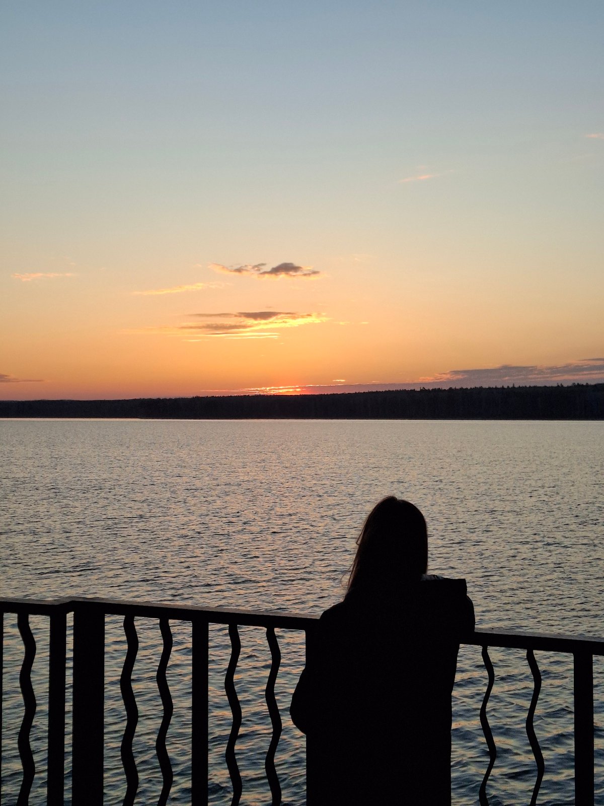 Peaceful sunset moments captured along Chaikovsky lakefront, Russia