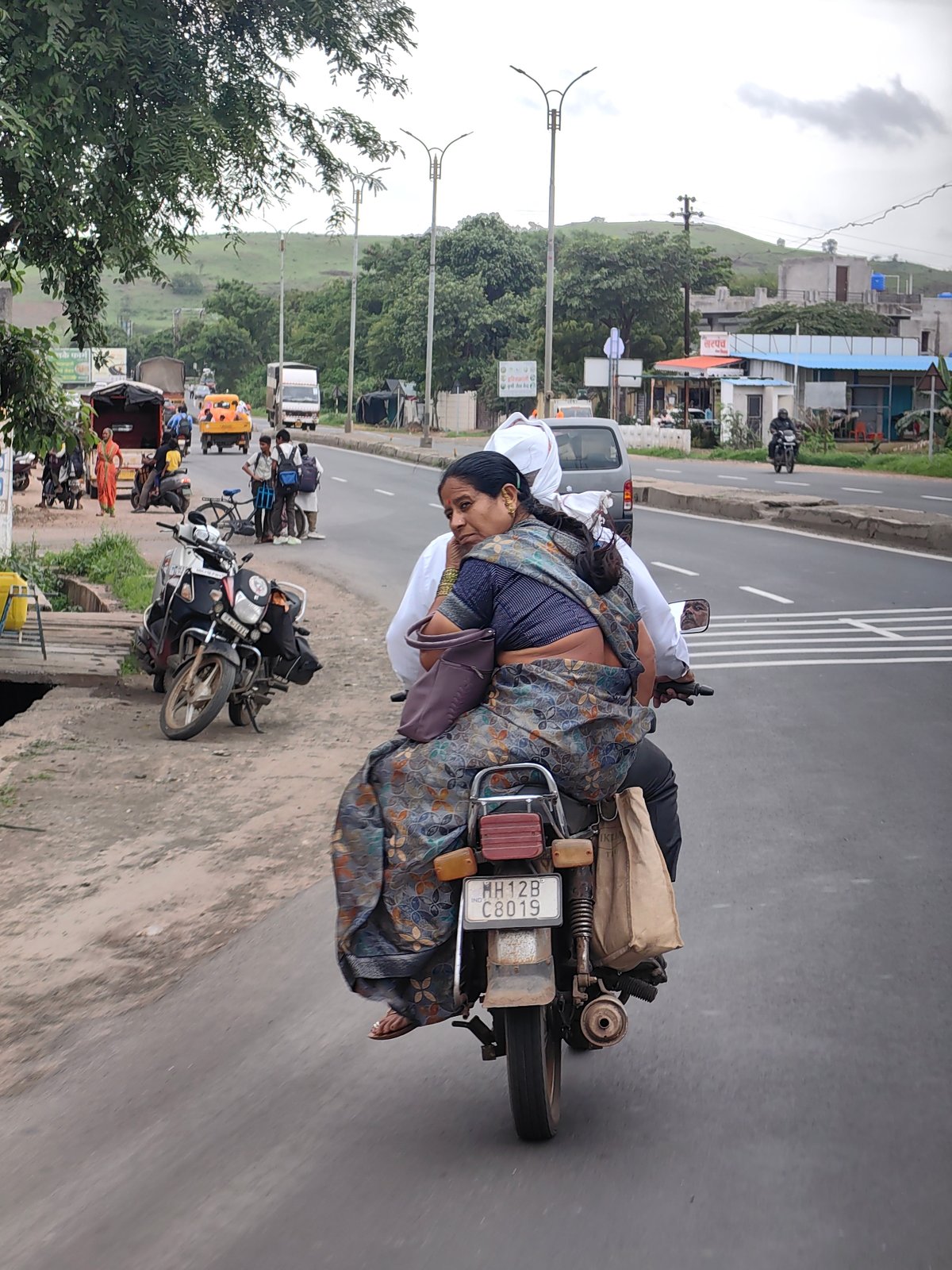 Motorcycle ride through Kedgaon streets on a cloudy day
